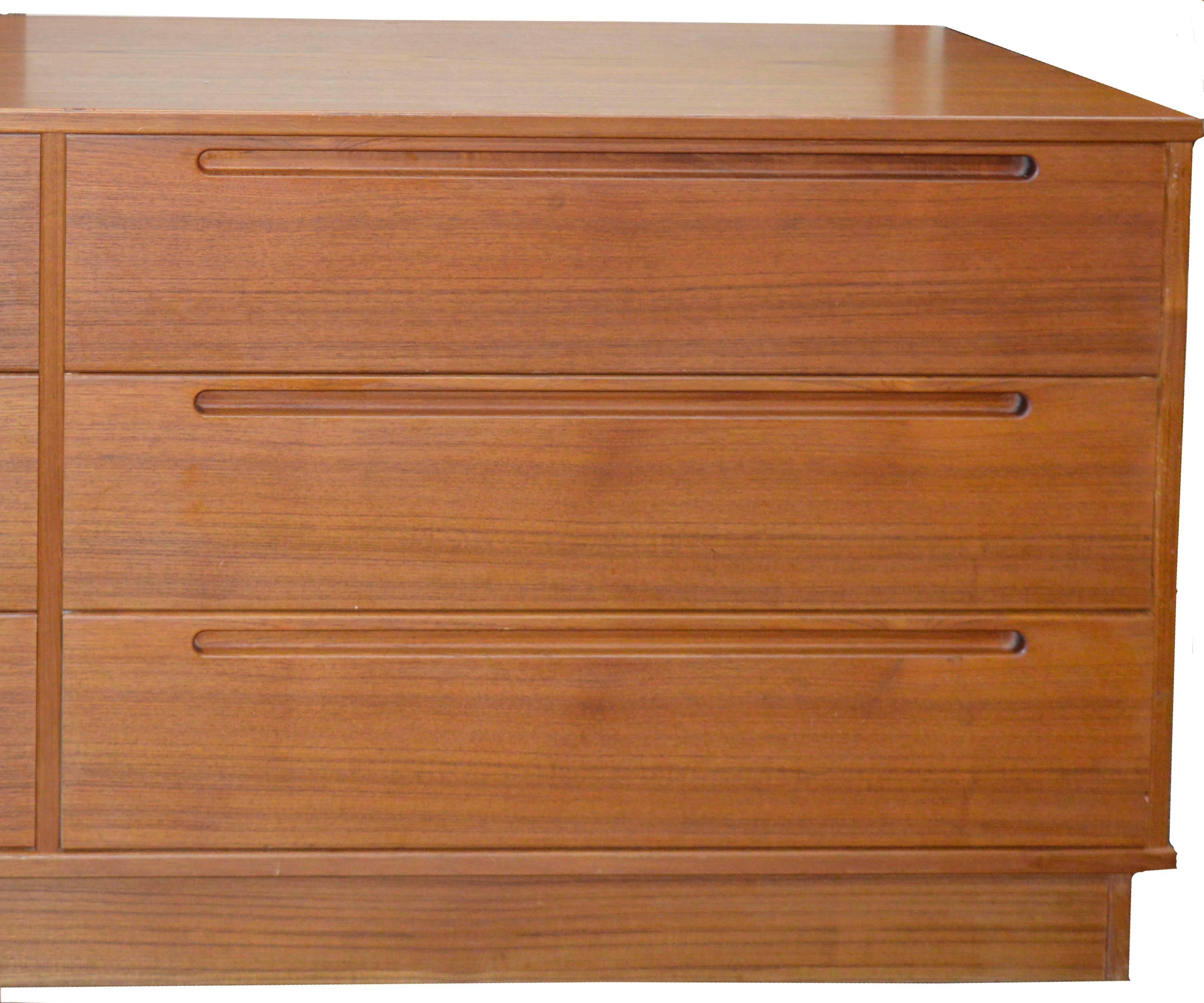 This Danish modern solid teak six-drawer double dresser, Arenkiel design, was designed for Torring Mobelfabrik, Torring, Denmark, circa 1965. Excellent solid hand oil rubbed Teak construction with White Birch wood drawer interiors. Excellent overall