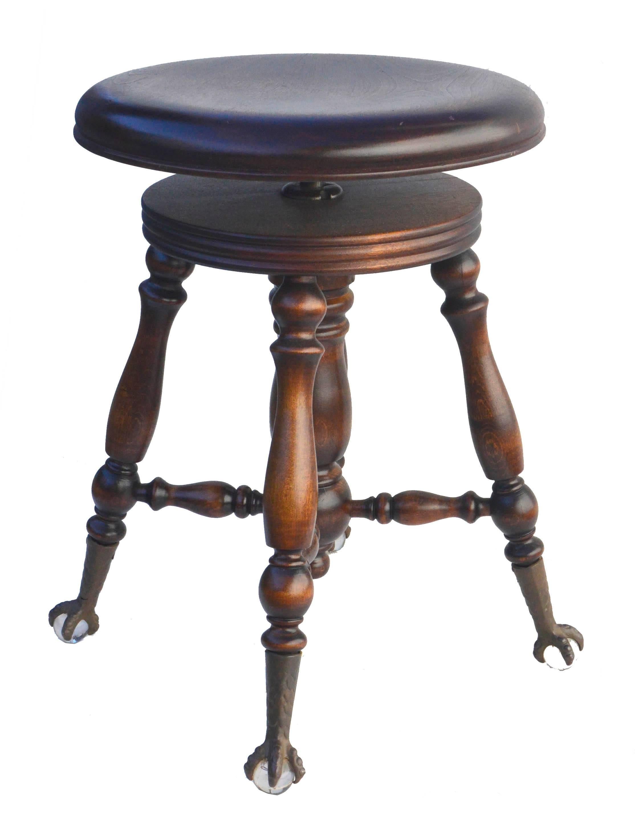 Gorgeous and rare piano stool with marvelous details and rich mahogany patina, this A. Merriam & Co piano stool has an adjustable-height seat with 