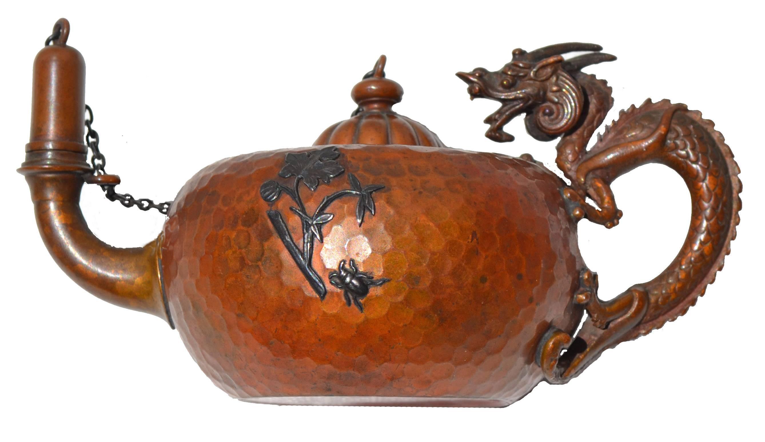 American Aesthetic period, copper, bronze and sterling silver handmade and hammered cigar lamp by Gorham Silversmiths, date marked for 1882. This nicely detailed Bronze dragon handle lamp has an applied sterling silver Butterfly and a Bee with