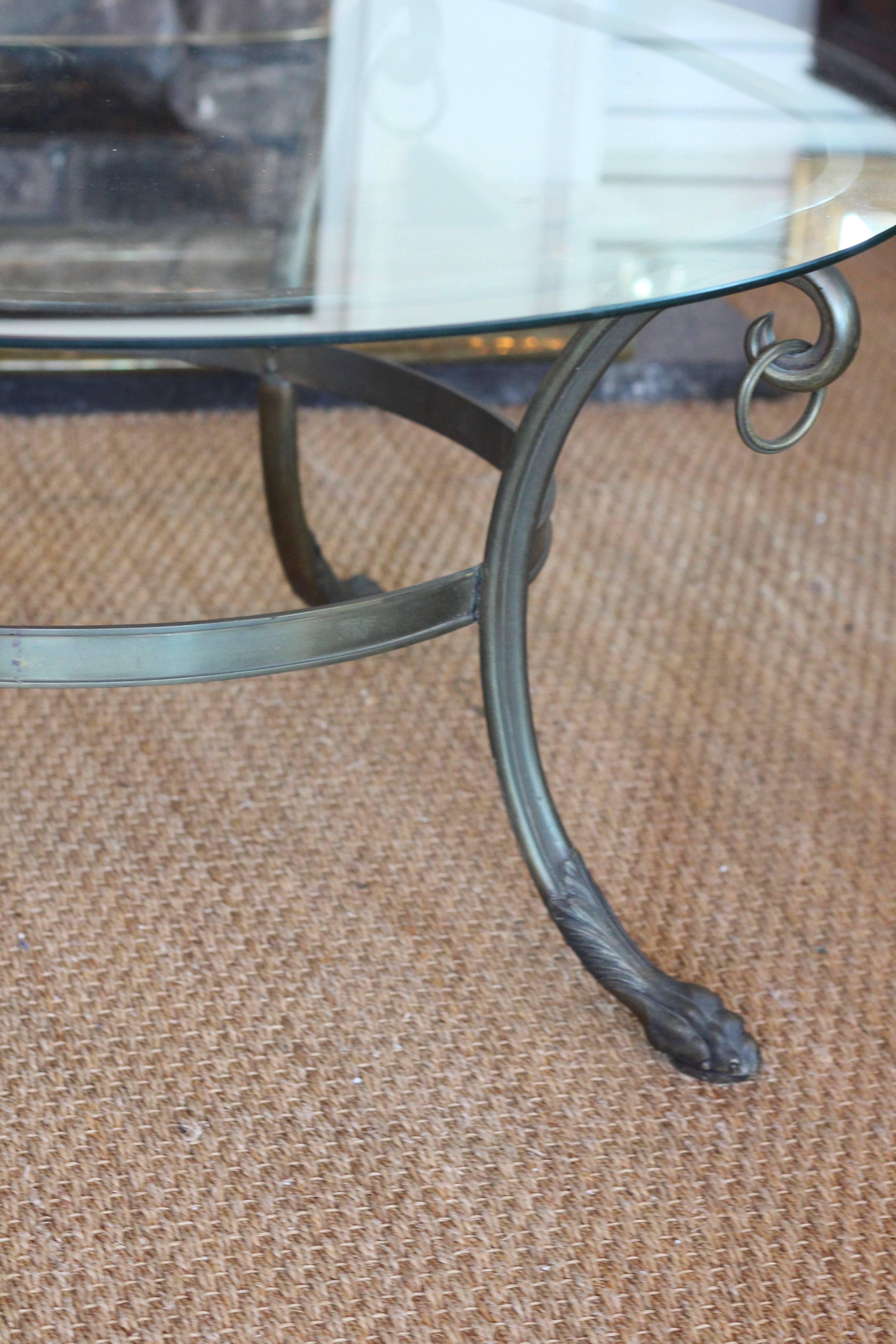 Handsome cast brass round coffee table with glass top from The Park Lane Hotel, London.