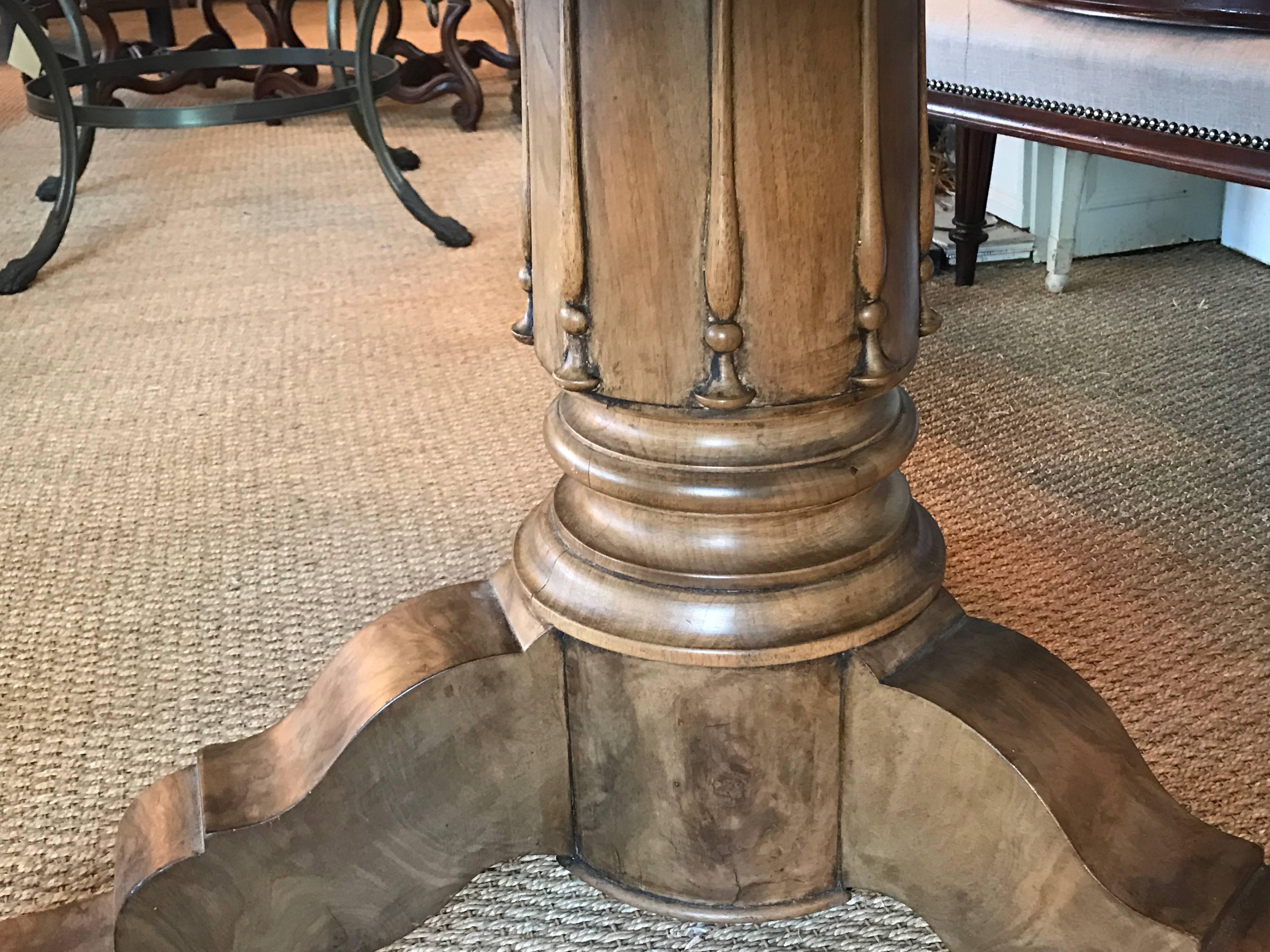 19th century center table made from burr walnut. Pretty column pedestal.