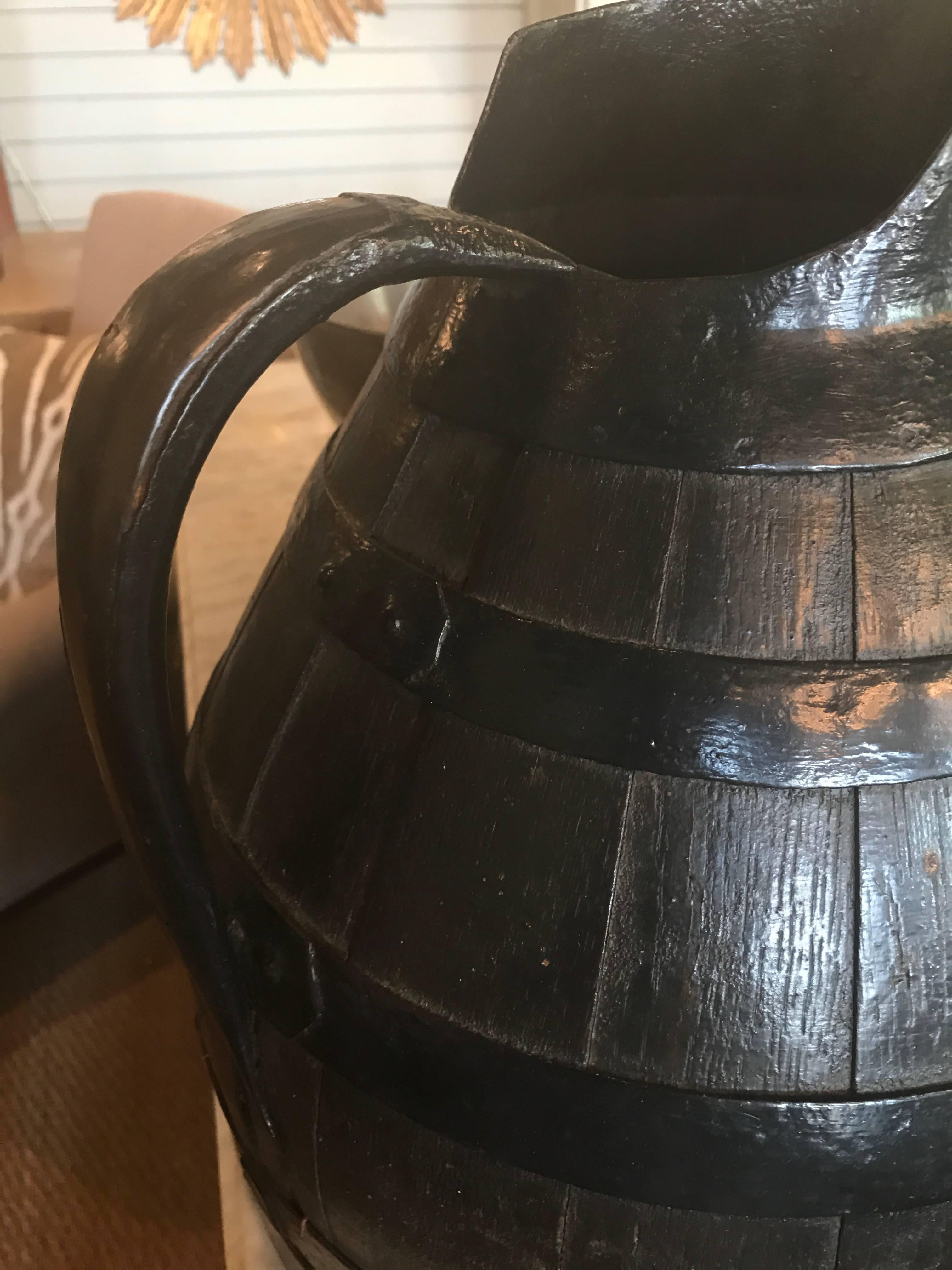 Late 19th century French wine pitcher with a combination of oak and tole banding.