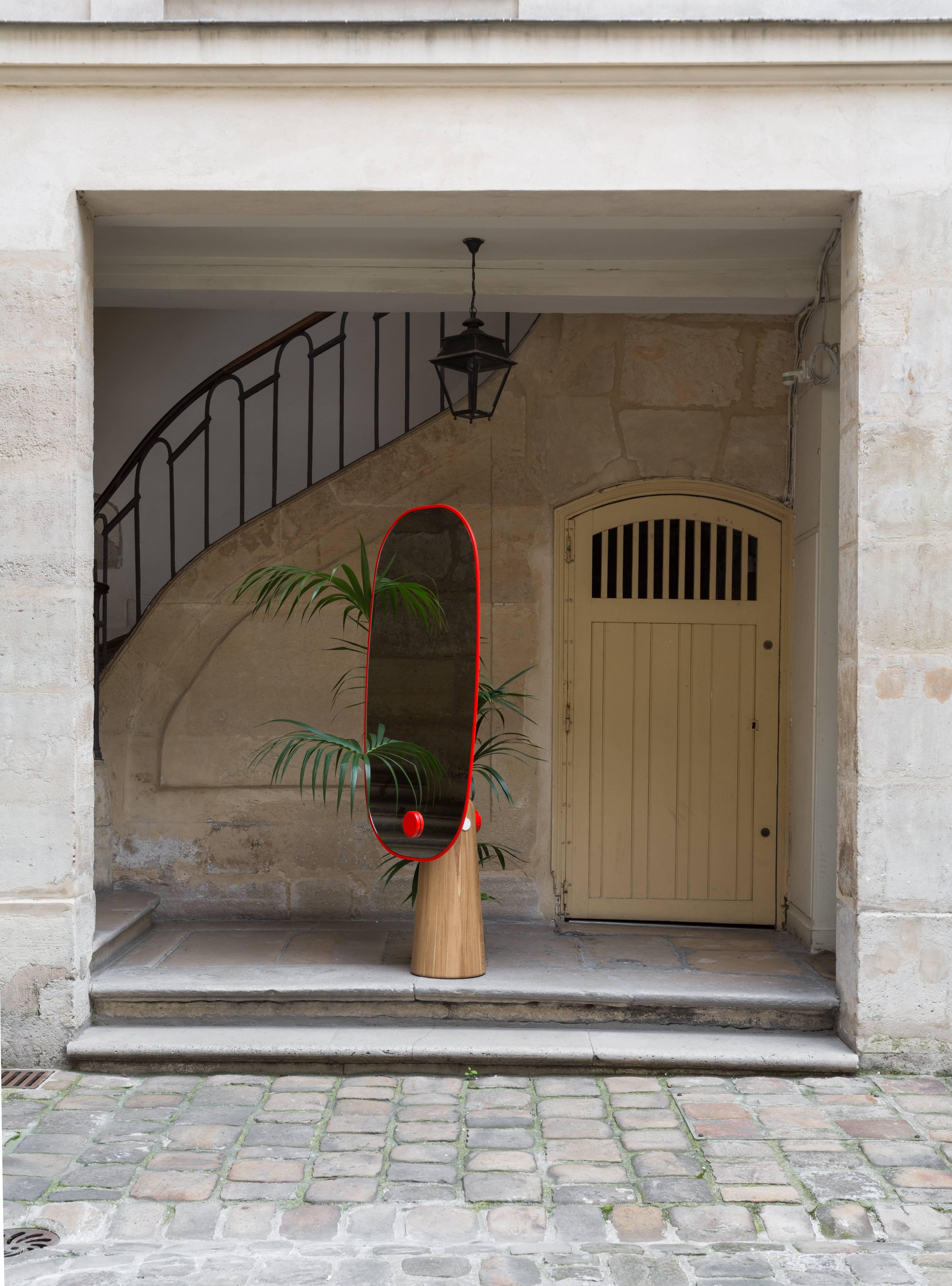 Iconic is a mirror that stands as a statue. The wood pedestal contrasts with the thickness of the mirror it supports. The metal cylinder sealed to the base makes the structure literally cross the mirror.

Dimensions, volume and weight
Height: