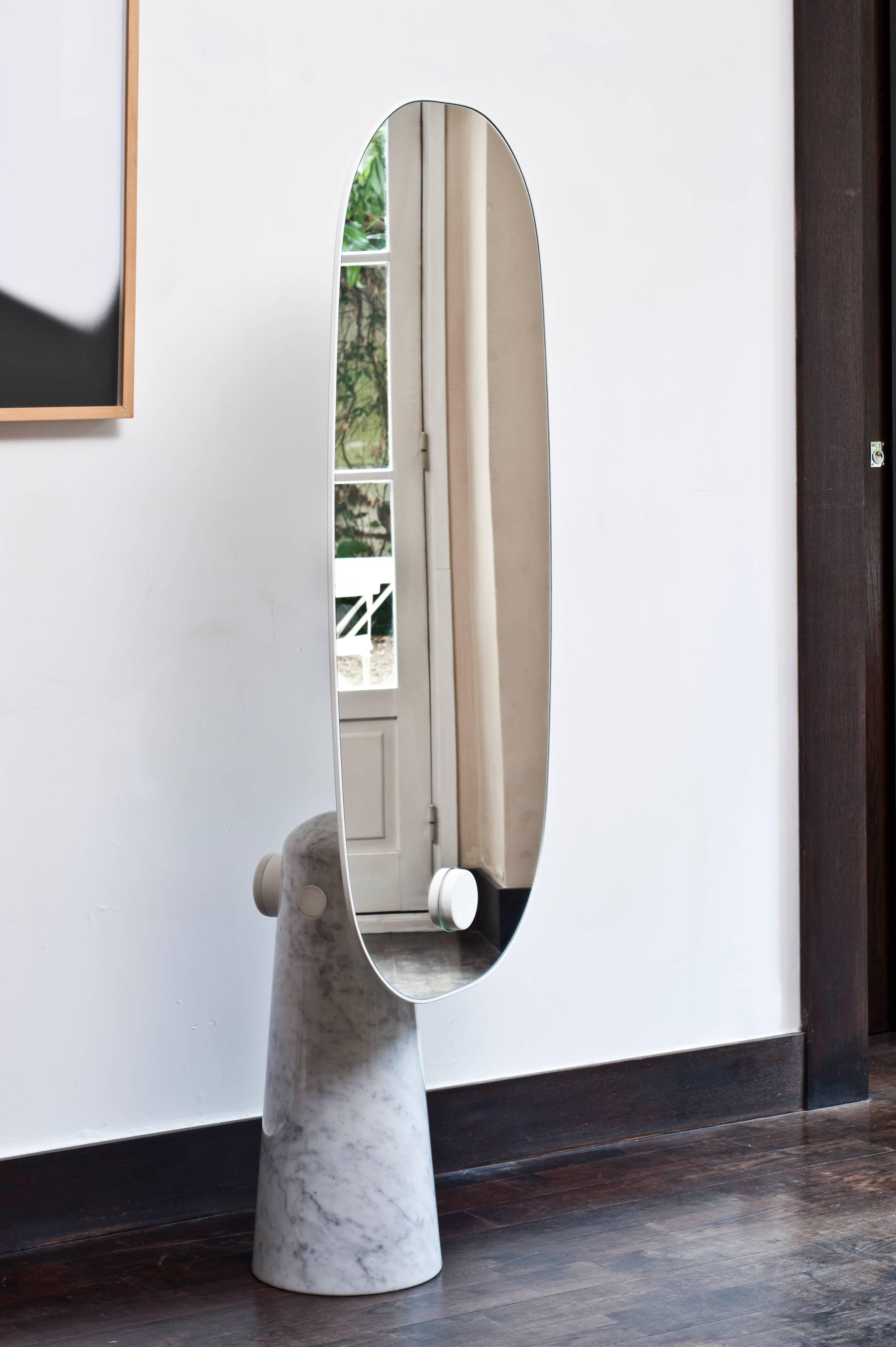 Iconic is a mirror that stands as a statue. The wood pedestal contrasts with the thickness of the mirror it supports. The metal cylinder sealed to the base makes the structure literally cross the mirror.

Dimensions, volume and weight
Height: