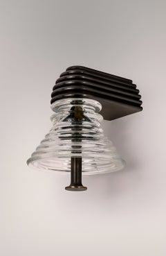Insulator A Clear Glass and Dark Brass Sconce by Novocastrian