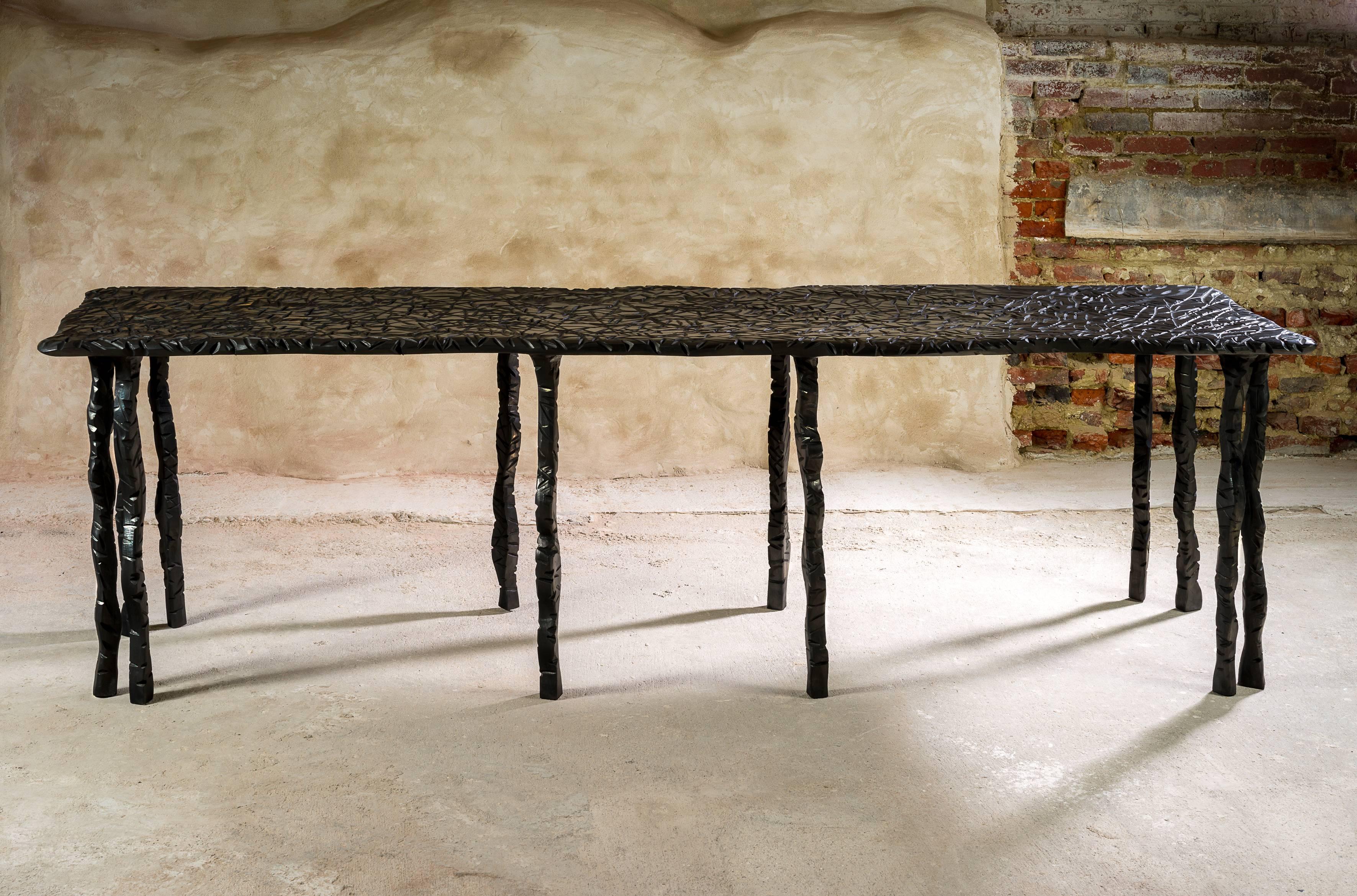 The Mille Pattes table is part of Charly Bounan's New Collection.
It is a unique hand sculpted low table by Charly Bounan.

Edition: 
Unique and signed.

Dimensions: 
82 x 269 x 70 cm 

Materials: 
Sculpted Wood with Graphite Wax

Charly