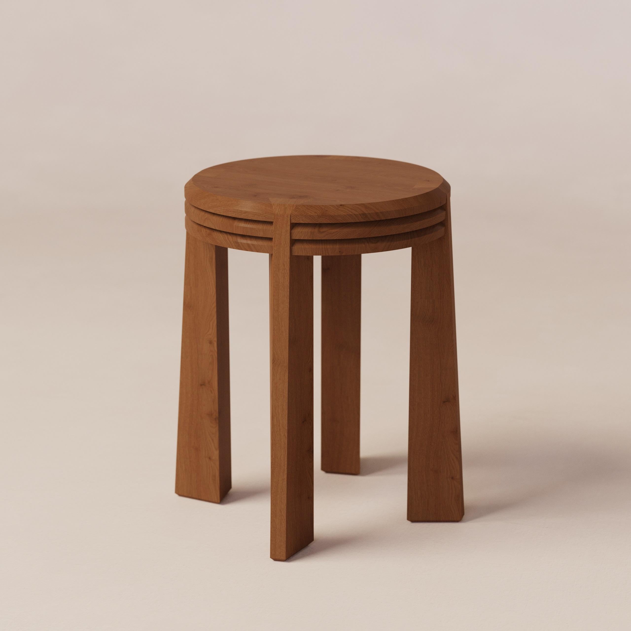 Prisma Oak Stool by Luis Gimeno
Dimensions: D 35 x W 35 x H 45 cm
Materials: Oak.

Four sleek prism-shaped legs support a top seat crafted from three layers of thick, dark brown ash wood.
Elegant, sturdy, and a perfect blend of sophistication for