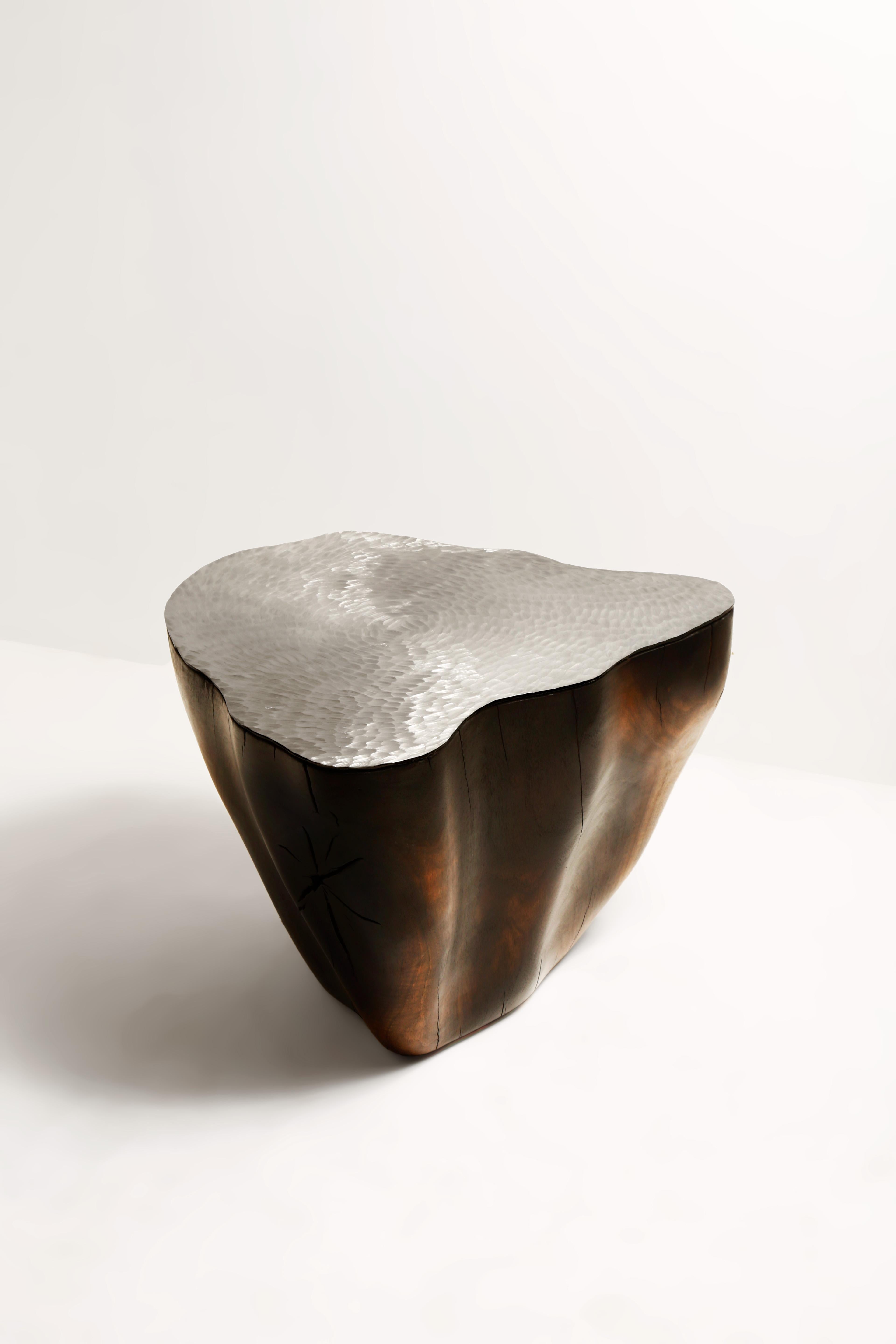 Duramen Stainless Steel Top and Solid Walnut Sculptural Object by Jules Lobgeois
Unique Piece
Dimensions: D 56 x H 38 cm.
Materials: Solid walnut, stainless steel.

The heartwood is the inner part of the wood and corresponds to the oldest growth