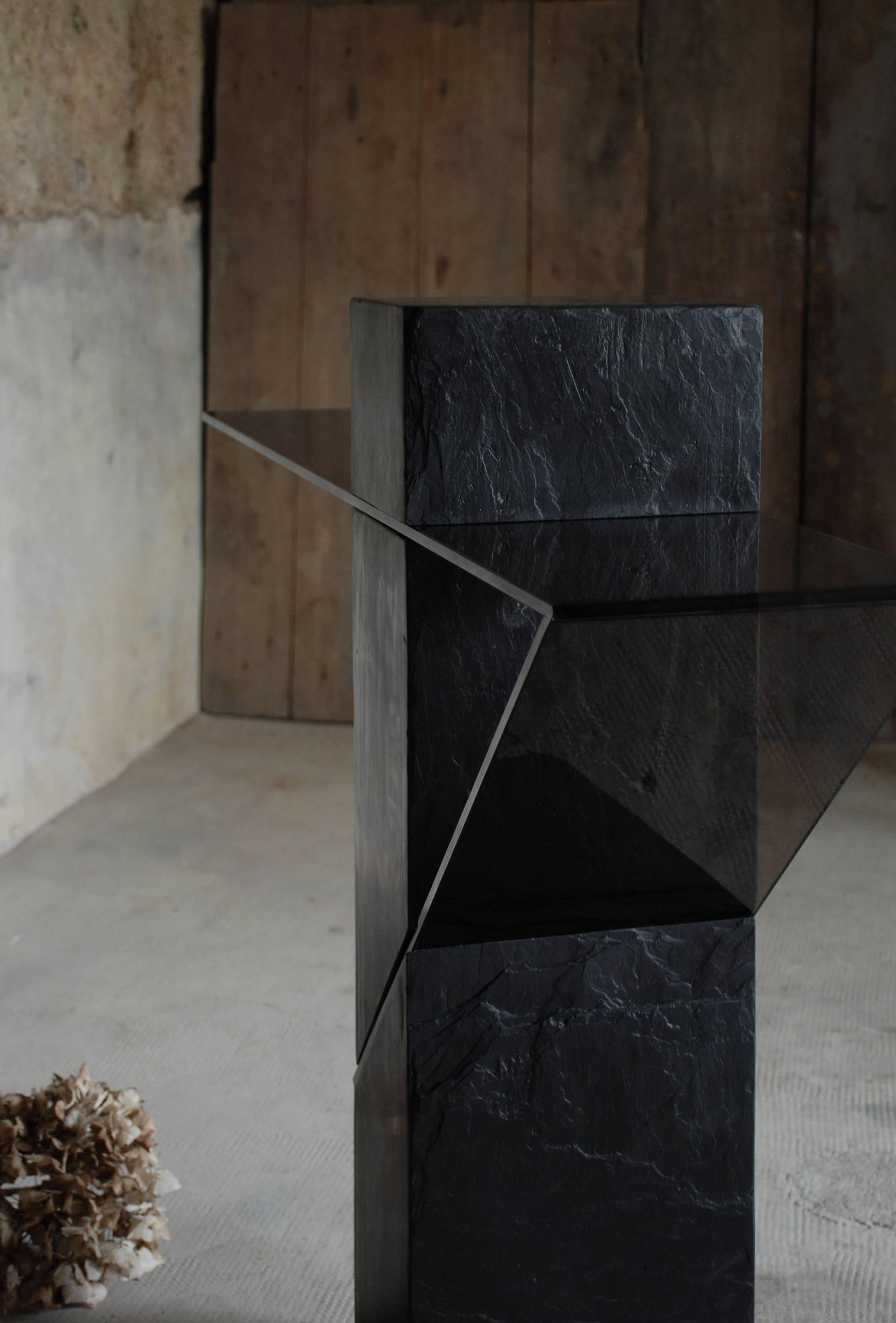 Athlétique console.
 Frédéric Saulou.
 Materials: Trélazé black slate - gray smoked glass.
 Dimensions: 87 x 110 x 18 cm.

 Edition of eight.
 Signed and numbered.

 “While wandering in the streets I have been observing buildings
