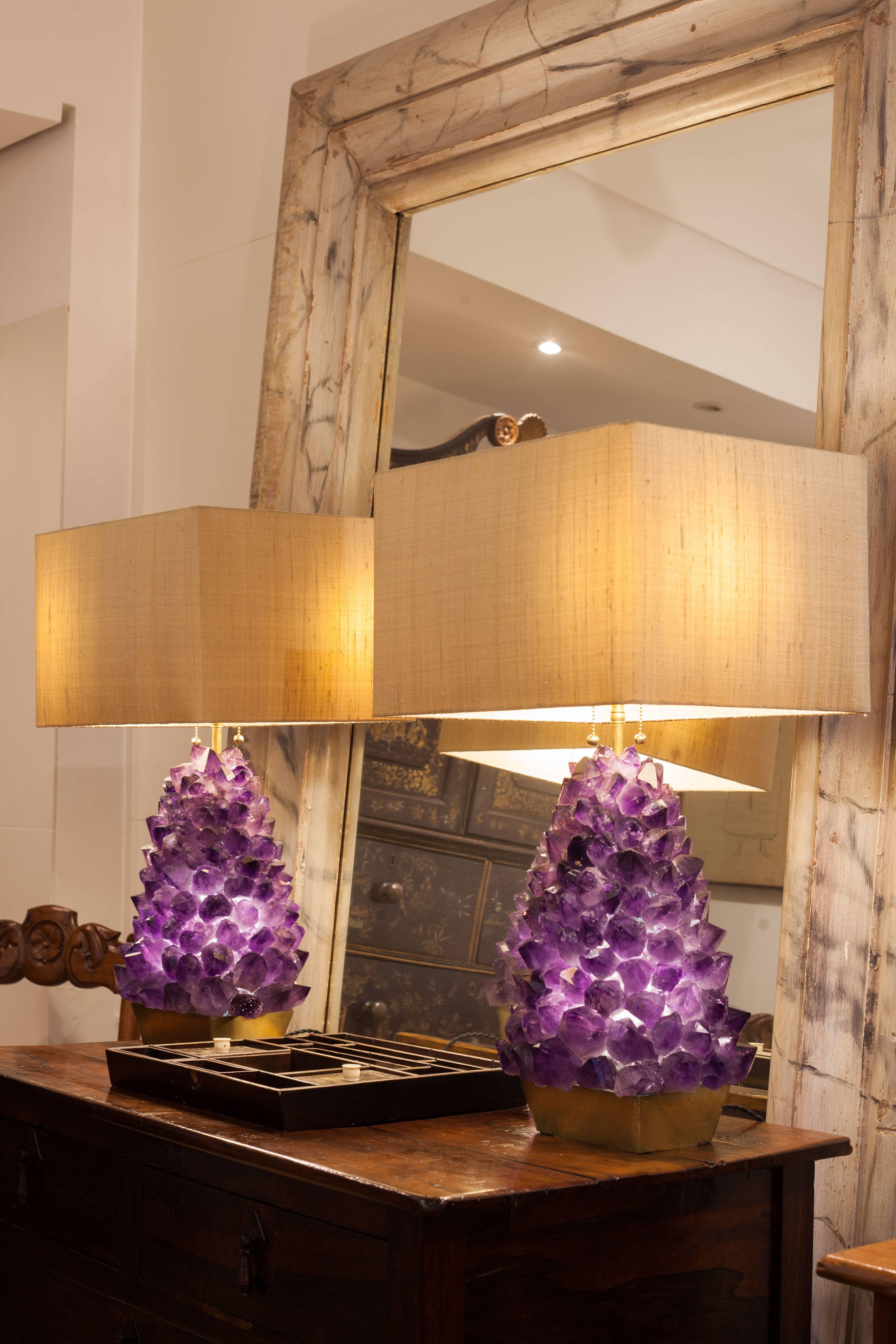 Unique pair of amethyst lamps, with approximately 170 brut rocks hand assembled on casted bronze base.

170 brut rocks.
Weight: 14 kg.
Internal 3,5W Led light and two external Led 9W lamps. Total 12,5 W on each with 3000K color tone. 127 V / 220
