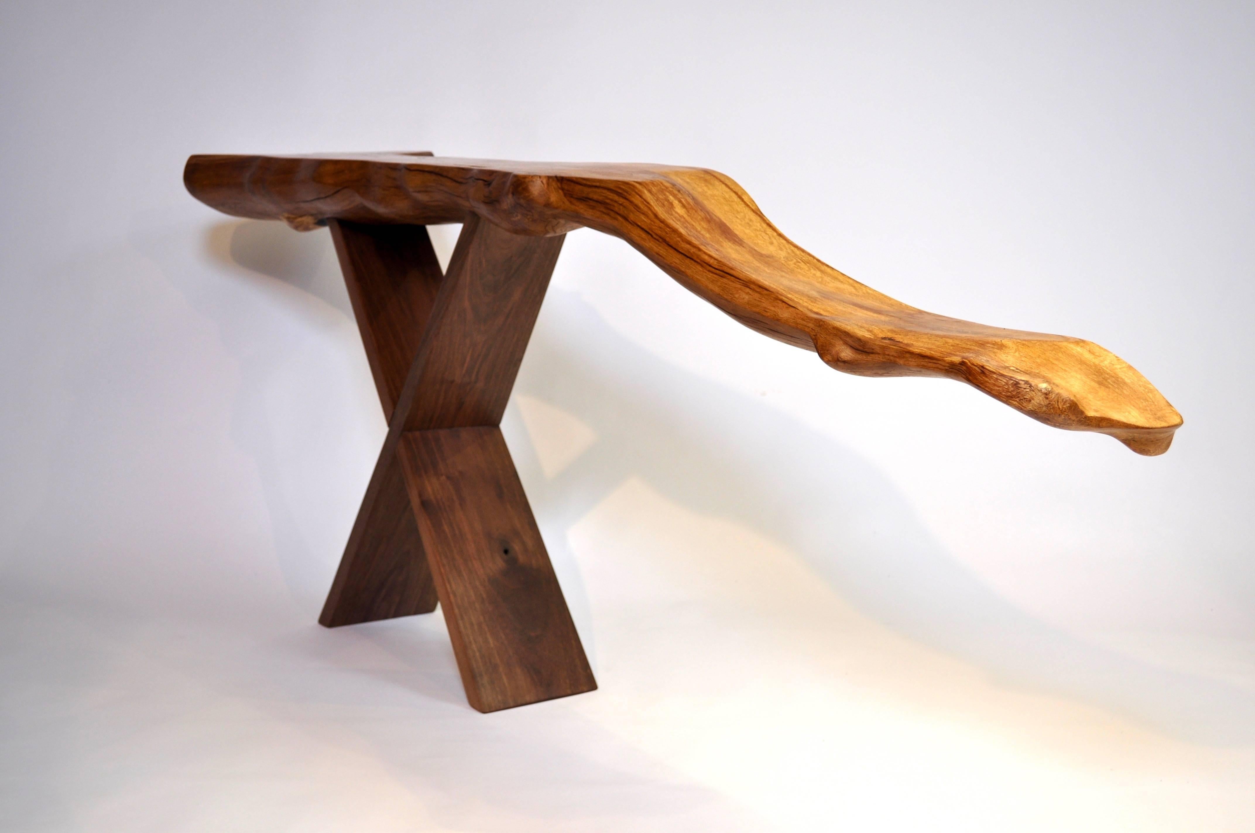 Unique signed console by Jörg Pietschmann
Console · Beech root, walnut 
H 75 X W 194 x D 34 cm
Curved piece of beech root on scissors stand of European walnut.
Polished oil finish.


In Pietschmann’s sculptures, trees that for centuries were part of