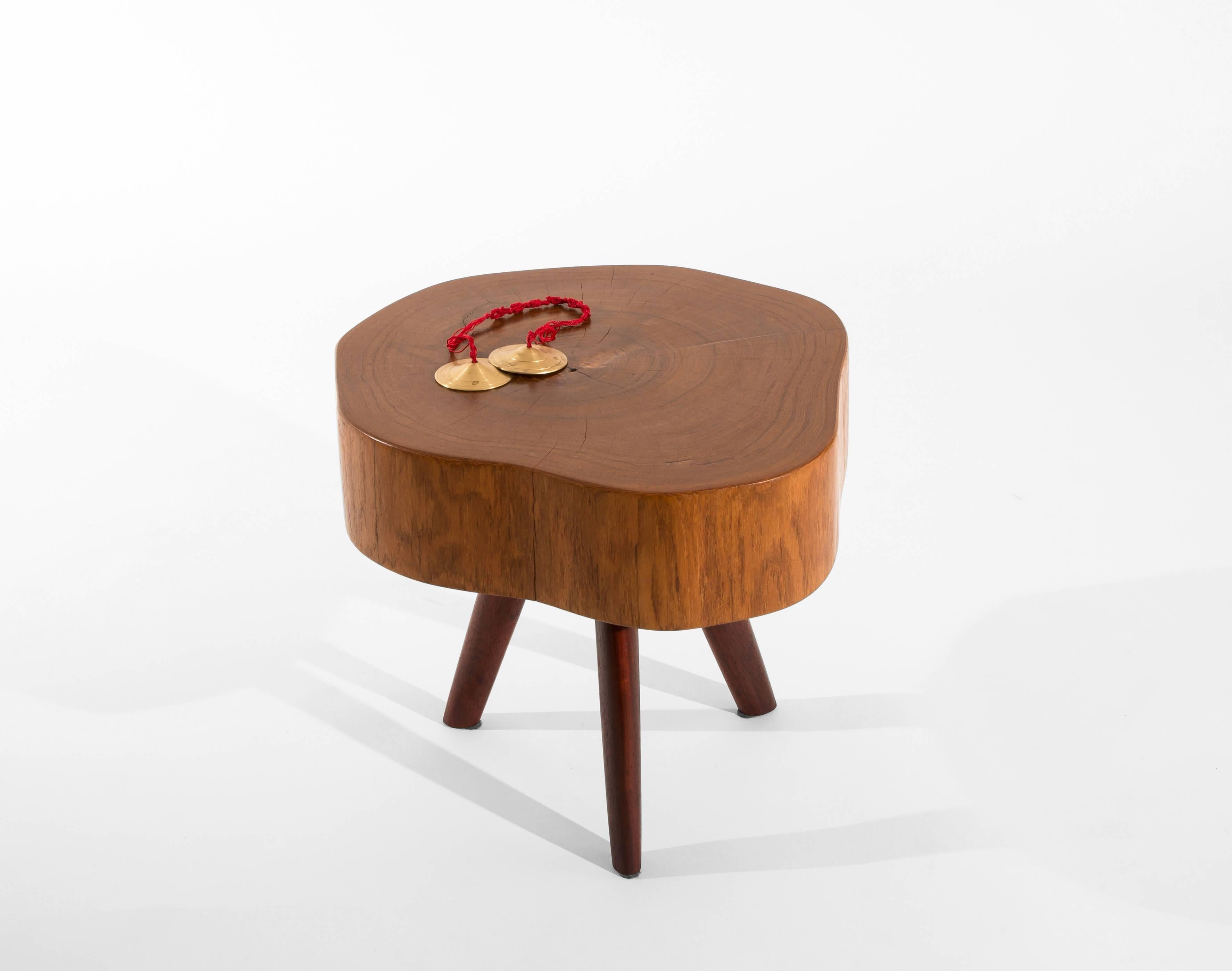 Unique signed table by Jörg Pietschmann
Side Table · Teak / Padouk 
Measures: H 37 x W 47 x D 43,5 cm tabletop 10,5 cm
Beautifully shaped and coloured stem section of teak wood
on three oval shaped, deep red legs from padouk.
Polished oil