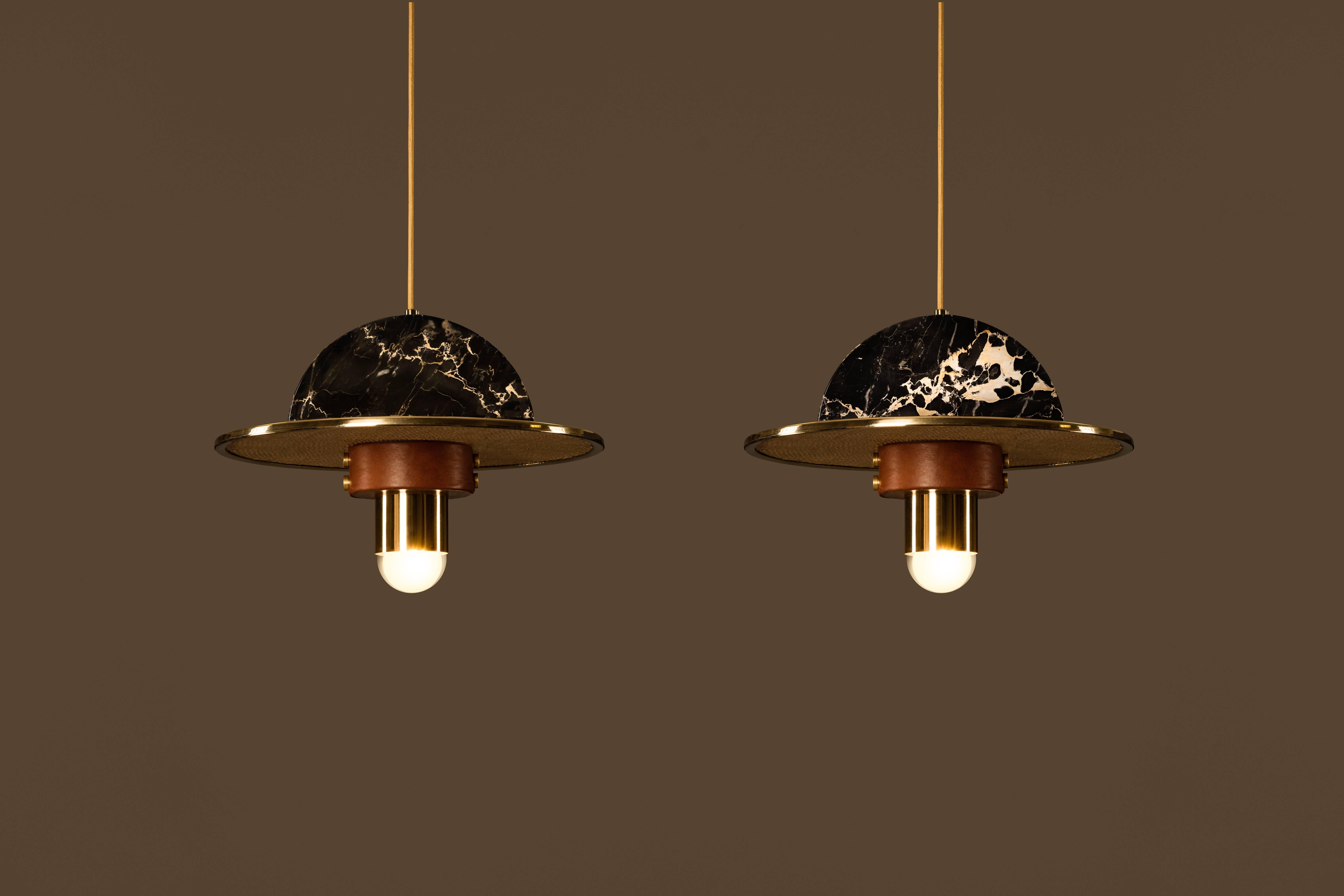 Pair of Shades Suspensions, designed by Masquespacio

Materials: Marble, cowhide leather, rafia fiber and metal brass structure.

Dimensions: W 40cm., H 24cm.
Lightbulbs: One x E27 100W max.

Masquespacio is an award winning creative