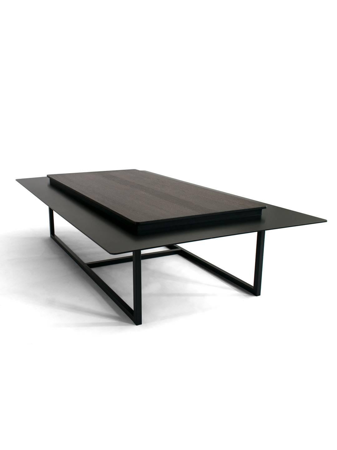 Tungen Coffee Table, Jan Garncarek
Materials: Steel, wood.
Dimensions: 33 x 130 x 80 cm.
Weight: 60 kg

The table consists of a wood top with a metal collar. This will enable the separation of everyday objects from those, that we want to expose on