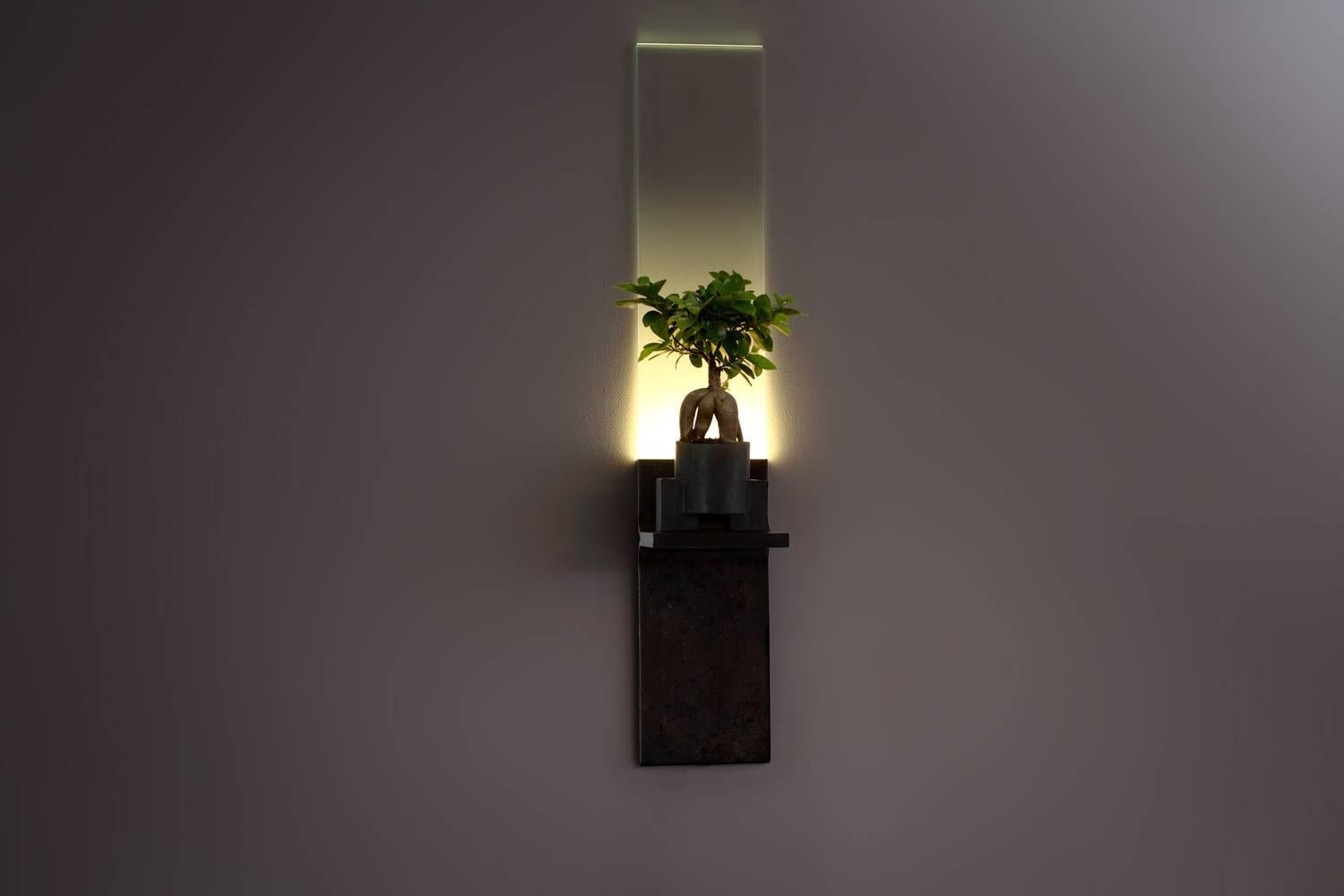 The monolith, brass LED light plant grower, Luvere Studio
Materials: Cold ? ?rolled ? ?steel, ? ?starfire ? ?glass, ? ?LED ? ?lighting
Dimensions: 37” ? ?x ? ?7” ? ?x ? ?7”

The monolith is a wall-mounted, full-spectrum LED light fixture