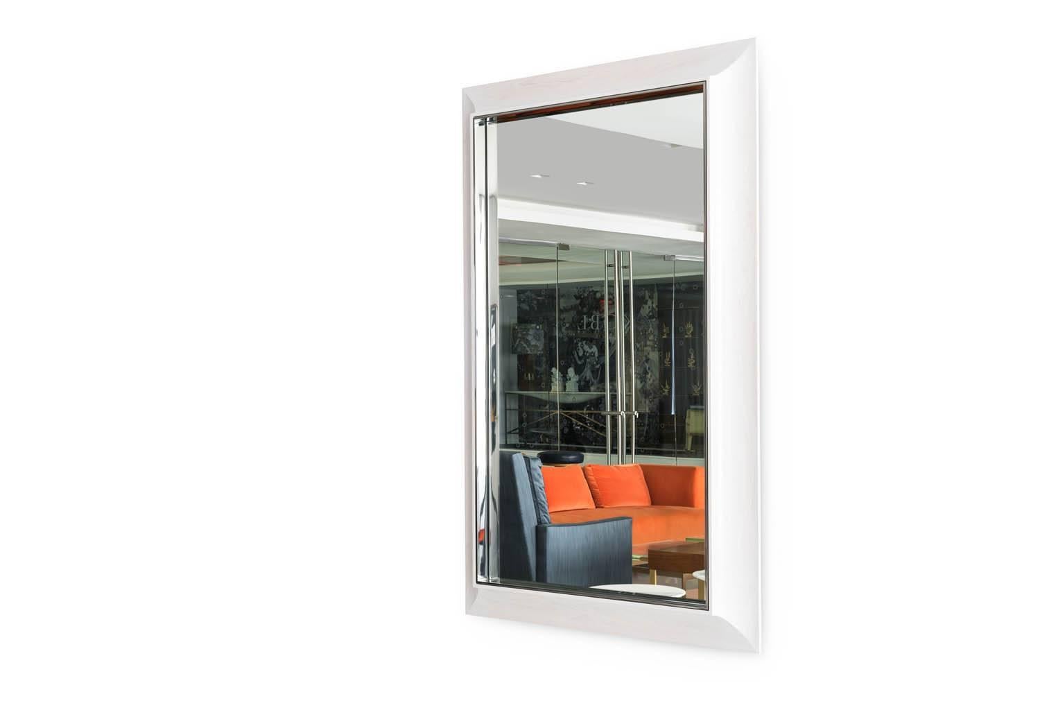 The Zamora Mirror is designed to extend the surface of the mirror onto the frame, via a highly polished stainless surround. The solid maple frame has a translucent stain which reveals the beauty of the wood grain. Shown in a White Stained Maple.
