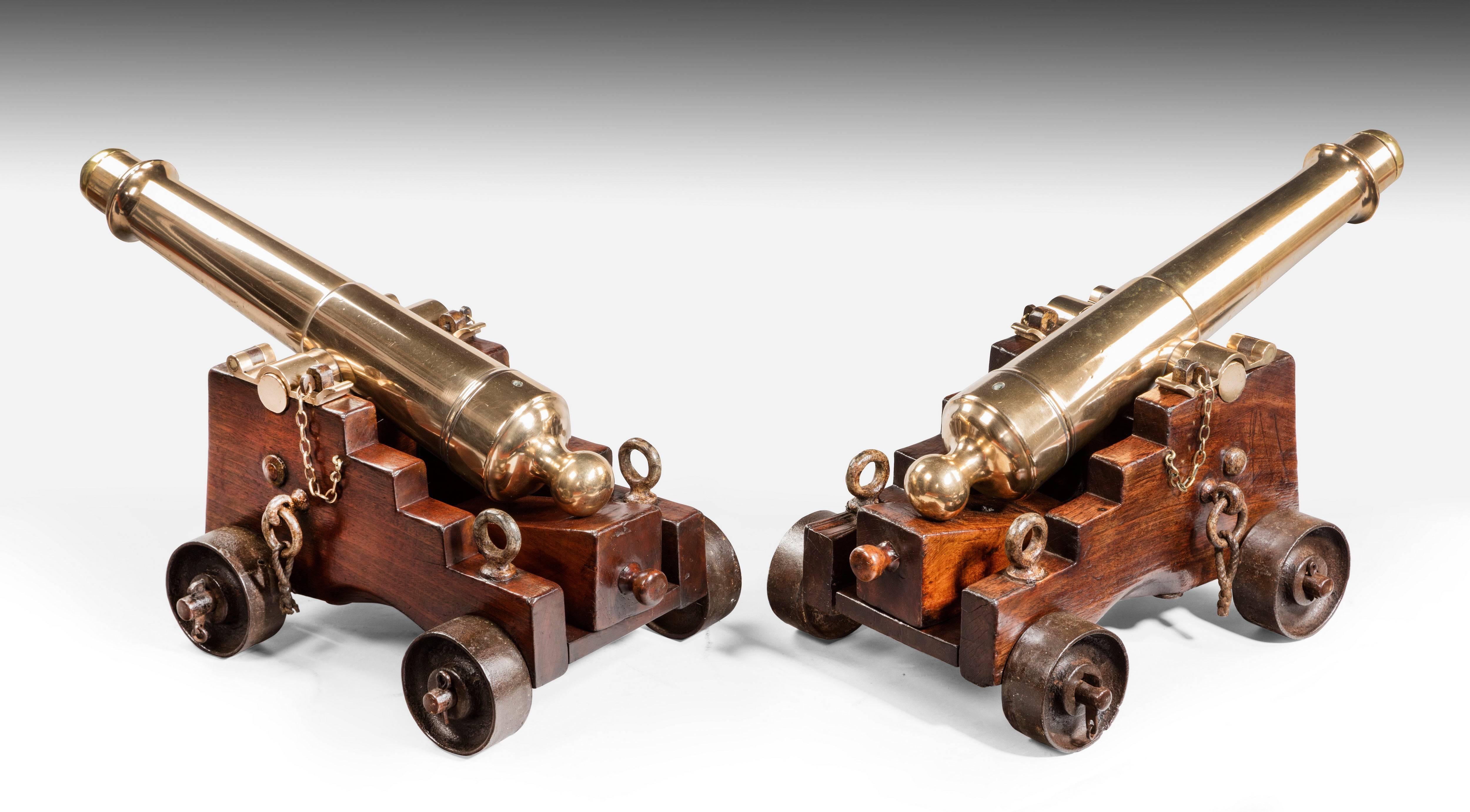 With brass stoppers. On original trunions and mahogany carriages. Complete with quoins/wedges on the bed, and iron tackle rings. Unusually on iron wheels/trunks. This type of lightweight cannon was probably made for a private yacht although it is