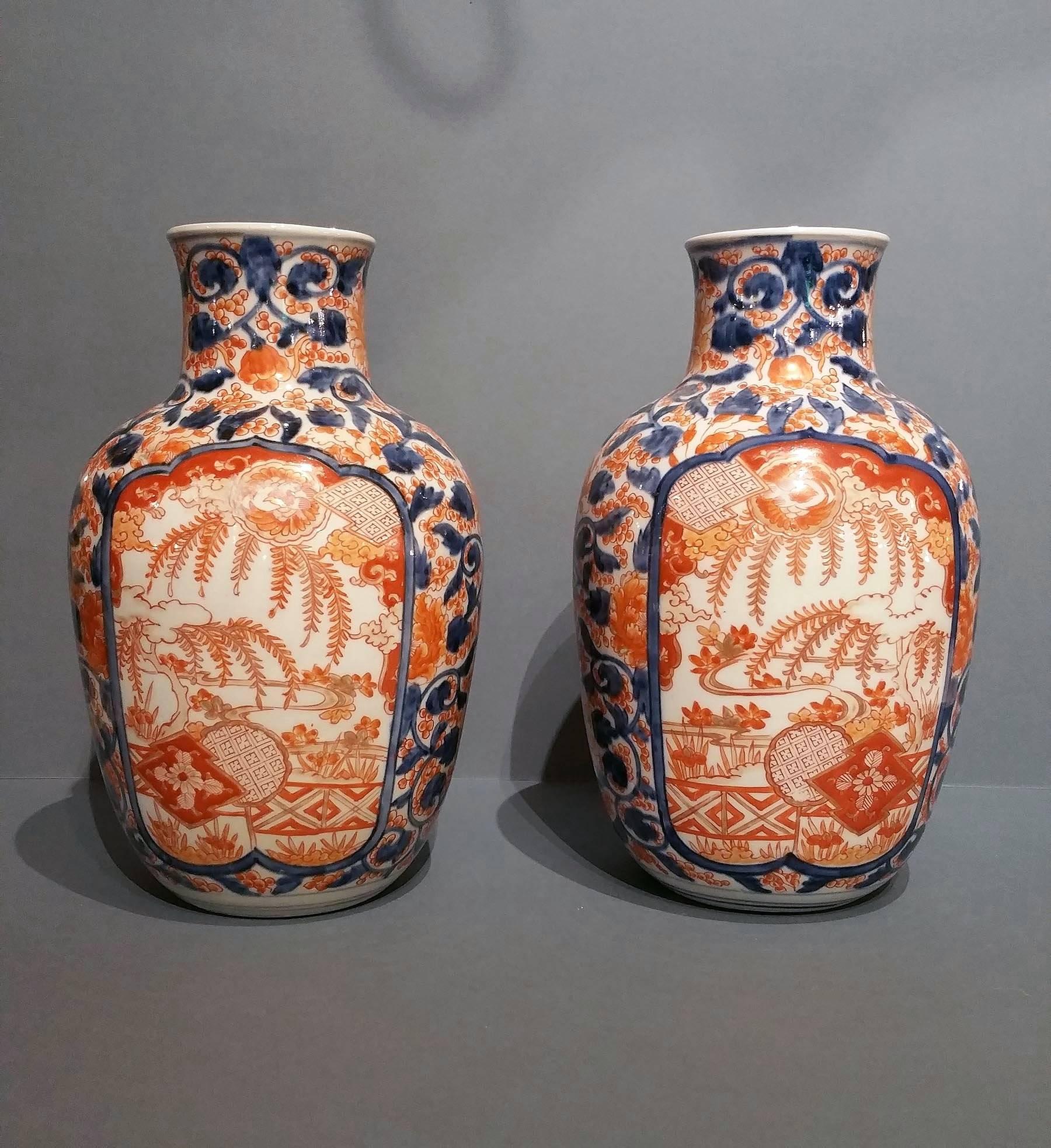 This lovely pair of 19th C. Imari Vases features a delicate elongated neck with a bright orange/red and dark cornflower blue profuse design of leaves and ferns. The vases measure 7 ½ in – 19 cm in diameter and 12 in – 30.5 cm in overall height.