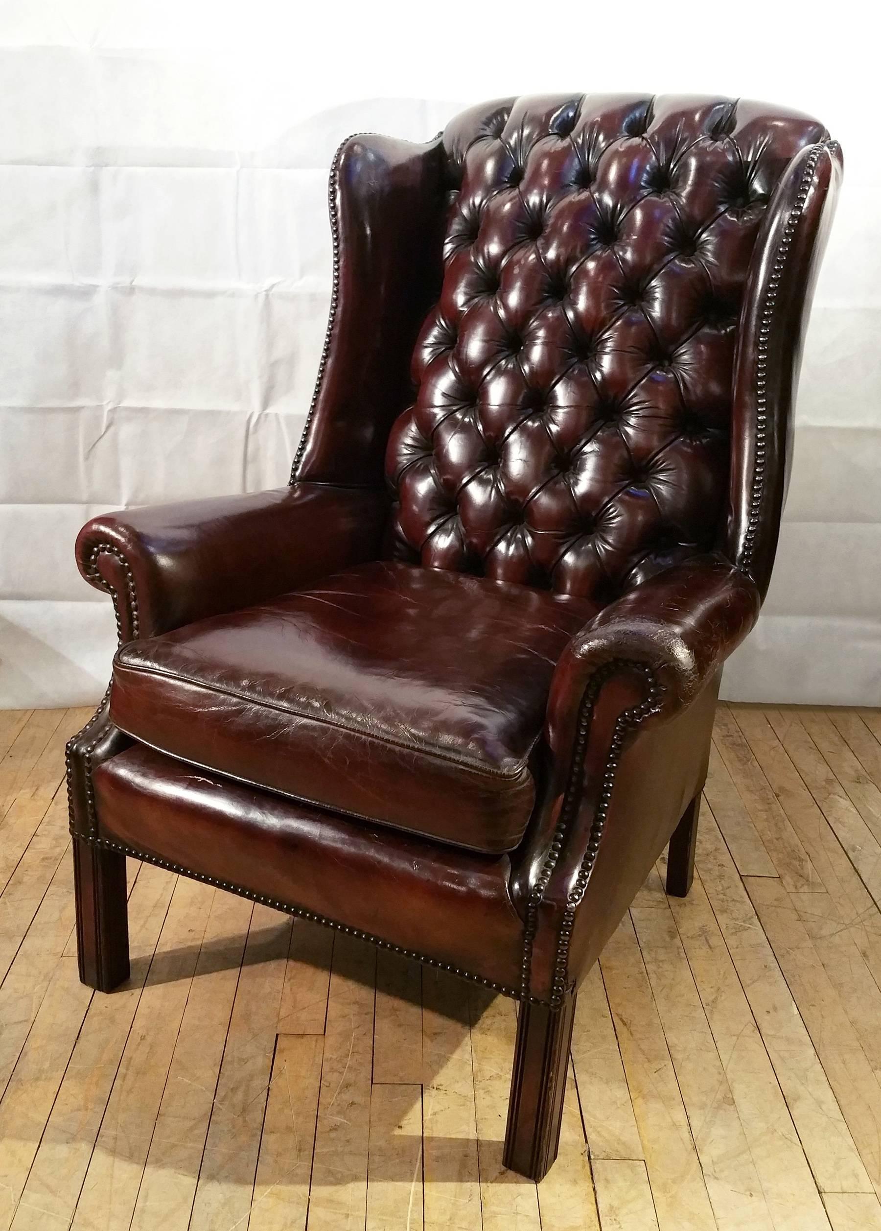 This gorgeous pair of deep buttoned leather wingchairs are upholstered in a rich warm dark burgundy color. The chairs feature a separate squab seat cushion with curled back arm rests and Stand on square leg supports. Each measures 29 ¾ in – 75.5 cm