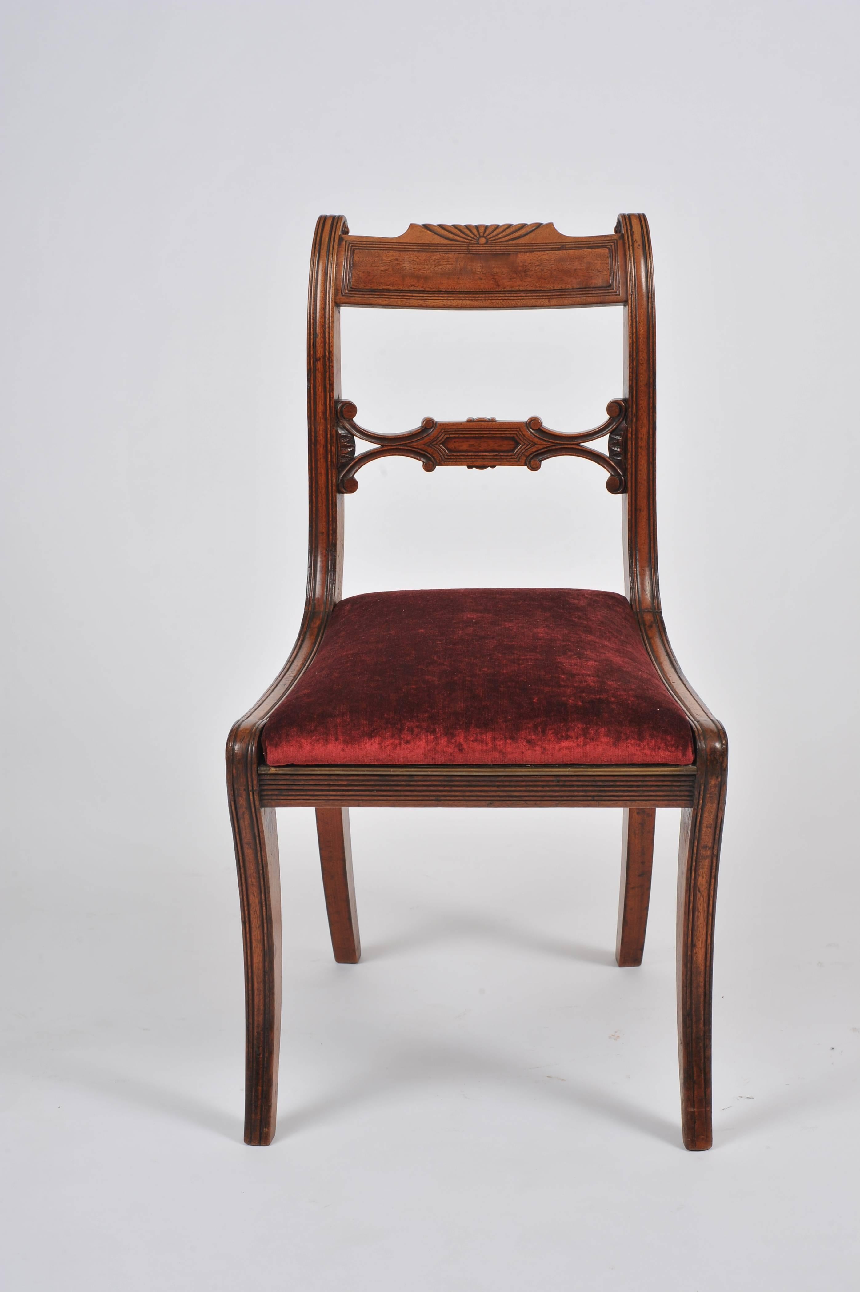 This attractive set of four Regency mahogany sabre leg chairs feature a deep burgundy crushed velvet upholstered drop in seat and scrolled back design. Each chair measures 19 in – 48.2 cm wide, 20 in – 51 cm deep and 37 in – 94 cm in height.