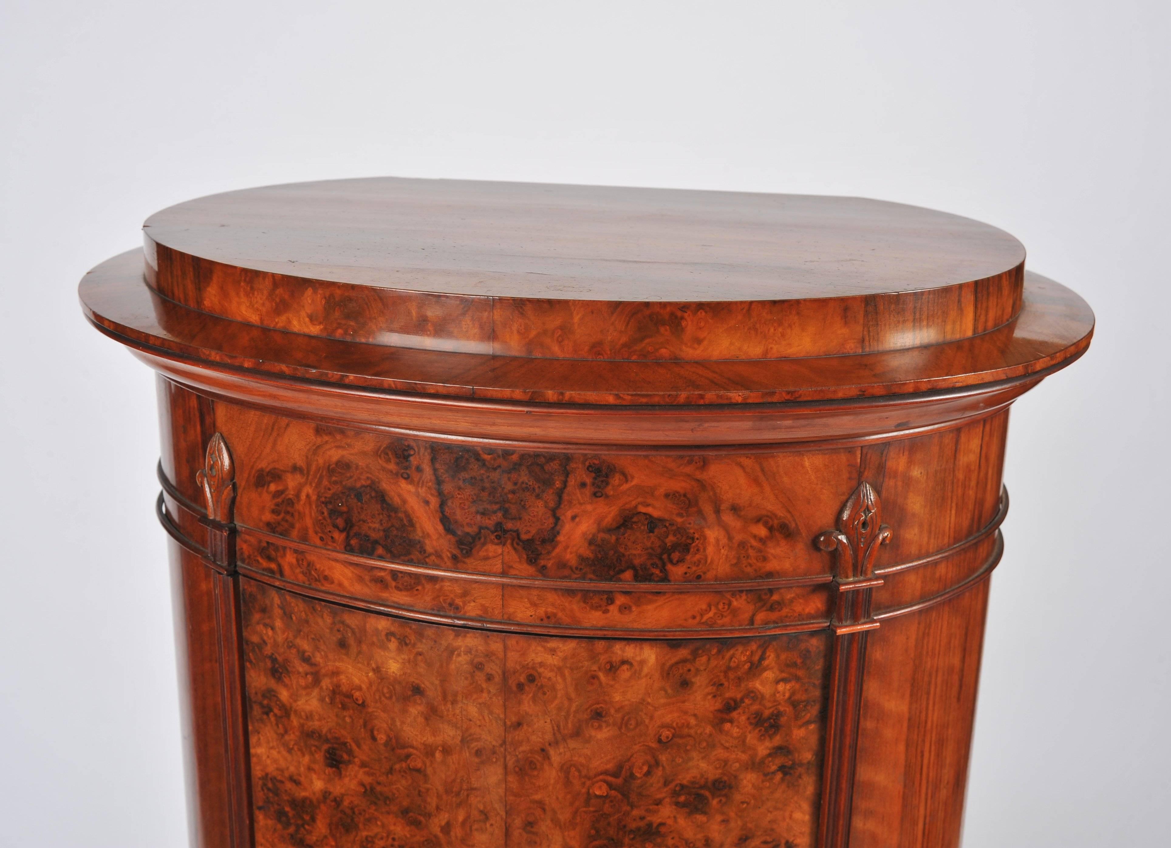 This marvellous and very appealing Victorian walnut pedestal cabinet features a more unusual oval shape and a burr walnut front. The cabinet has a full length central door which opens to reveal three fixed shelves. It measures 24 in – 61 cm wide, 15