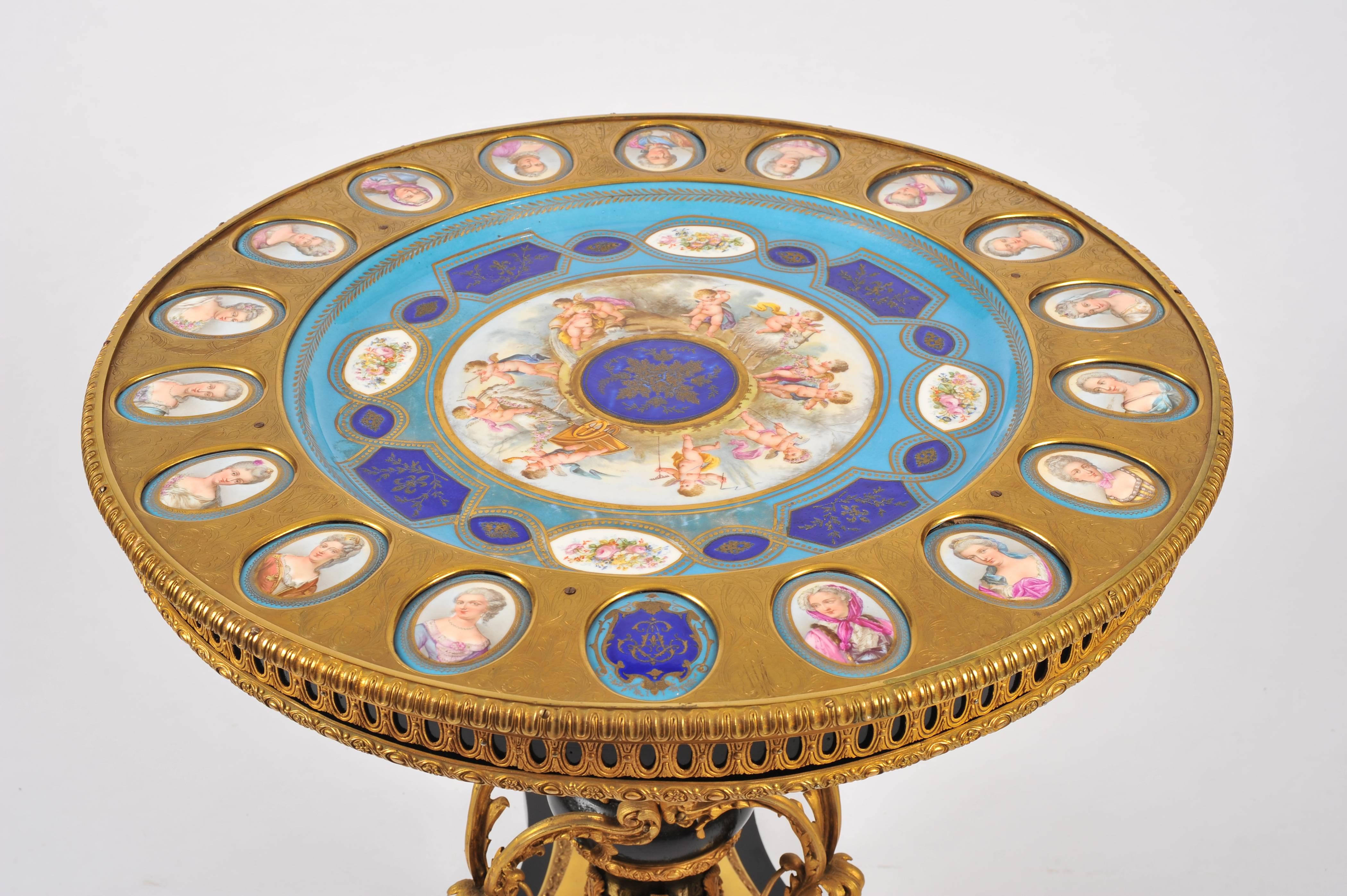 This magnificent ormolu table is supported on an ornate triform pedestal base. The top features a gilt bronze pierced gallery and a large and stunning Sevres porcelain plate encircled by 18 portrait plaques. This table would make a beautiful focal