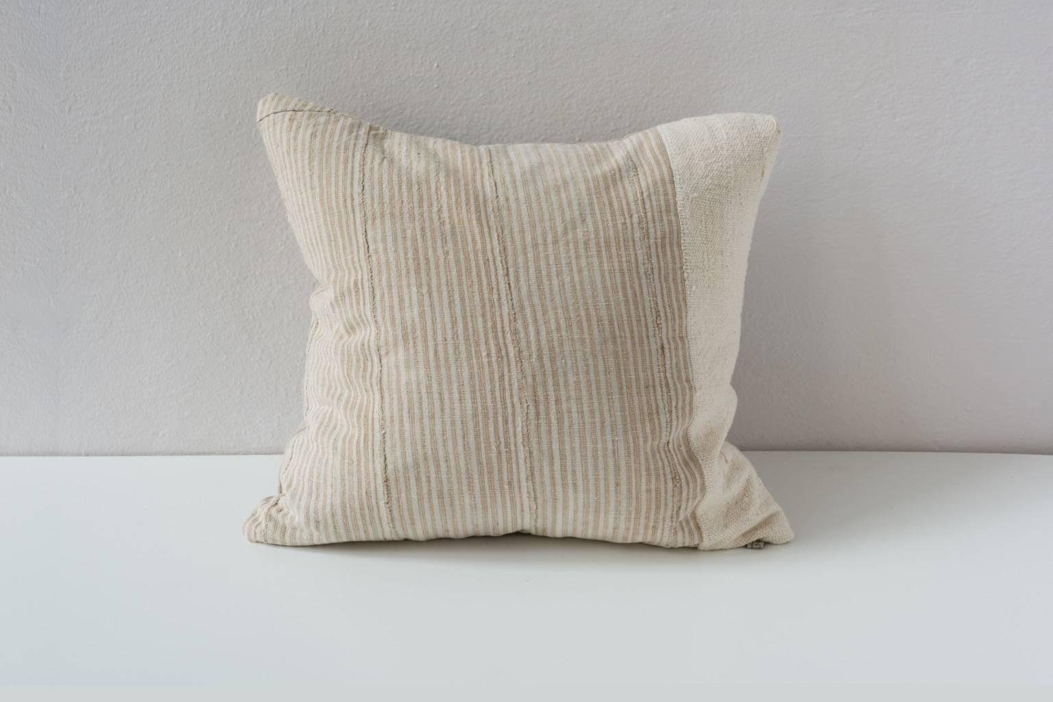 A mirrored set of piecework Hausa Yoruba handwoven striped fabric with a cream colored Mali stripe. 

- Linen on reverse, see image
- 75/25 goose feather and down inserts.
- Concealed zippers.
- Check our 1stdibs storefront for pillows in