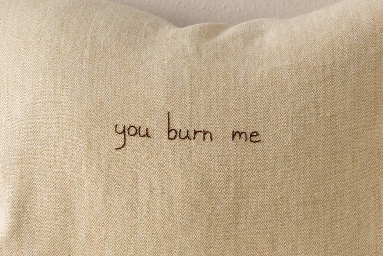 Contemporary cushion in washed soft thick cream herringbone linen with embroidered text from one of Sappho's fragments: you burn me. 

Same Linen on reverse.
75/25 goose feather and down inserts.
Concealed zippers.
Check our 1stdibs storefront