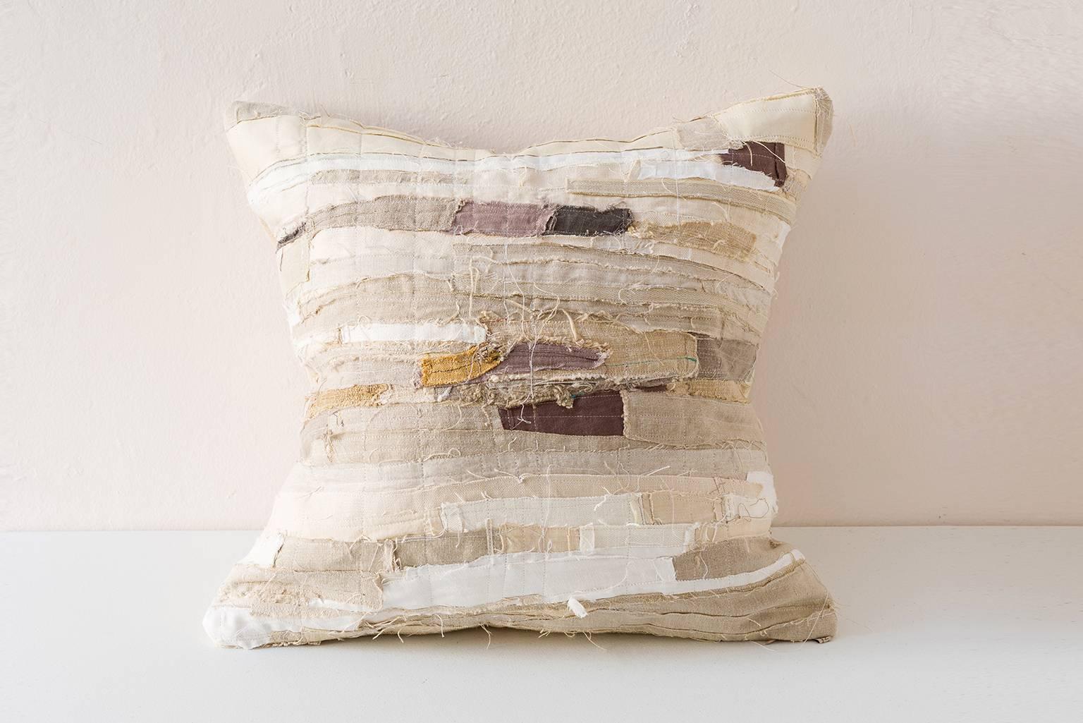 Raw edge piecework cushion in ecrus and creams with dark grey or mauve highlights. Combinations of contemporary and vintage linen fragments: cotton, raffia, hemp and or raw silk from Africa, Europe, Asia. 


Linen on reverse see image.
75/25