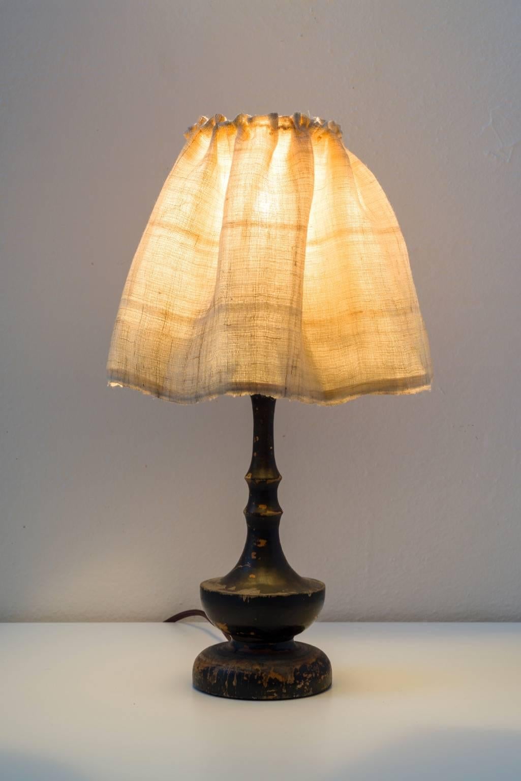 Lampshade made from hand loomed Hmong hemp. Hand sewn and finished on a bulb clip frame. Married with a vintage wood turned candlestick lamp base. LED bulb/ on and off switch socket. Cloth wire. 
Newly made from Vintage pieces.