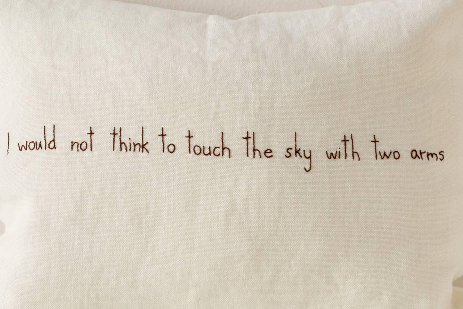 Contemporary cushion in washed soft thick white linen with embroidered text from one of Sappho's fragments: I would not think to touch the sky with two arms. 

Same linen on reverse.
75/25 goose feather and down inserts.
Concealed