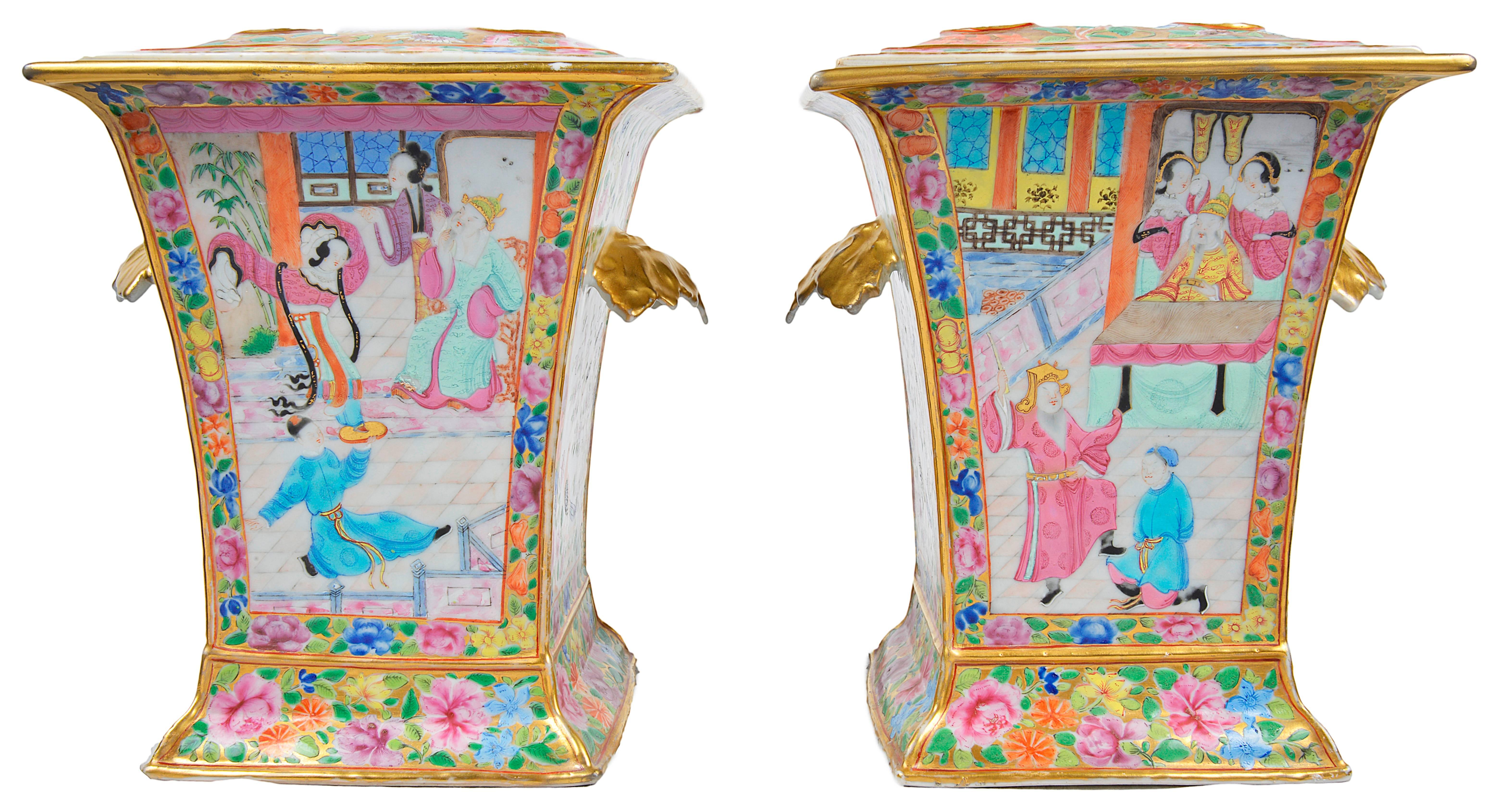 A very good quality pair of Chinese Canton bough vases. Each having pierced lids, decorated with various exotic flowers, gilded boarders and petal handles. Panels to the front depicting classical interior scenes.