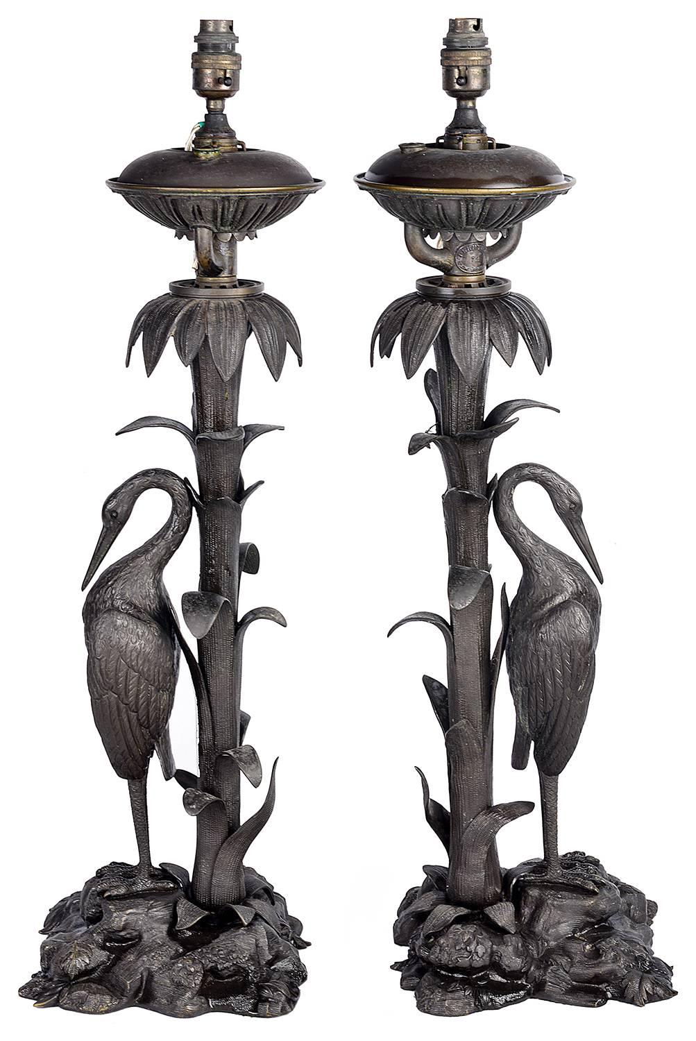 A very decorative pair of 10th century bronze lamps, depicting Cranes under Palm trees and standing on a rocky outcrop. 
Stamped with the makers name; Perry, New Bond Street. London.