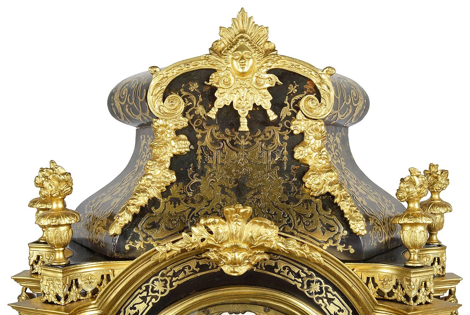 A very impressive late 19th century Boulle inlaid mantel clock. Having scrolling, gilded ormolu mounts, an eight day striking movement with white enamel numerals. Caryatid and Horse mounts to the clock case and raised on a plinth base.