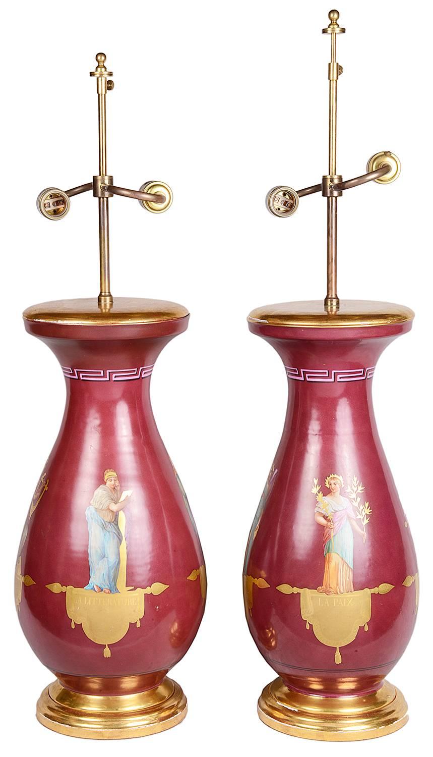 A very good quality pair of 19th century Paris porcelain vases or lamps. Each depicting classical Roman figures with a burgundy ground.
