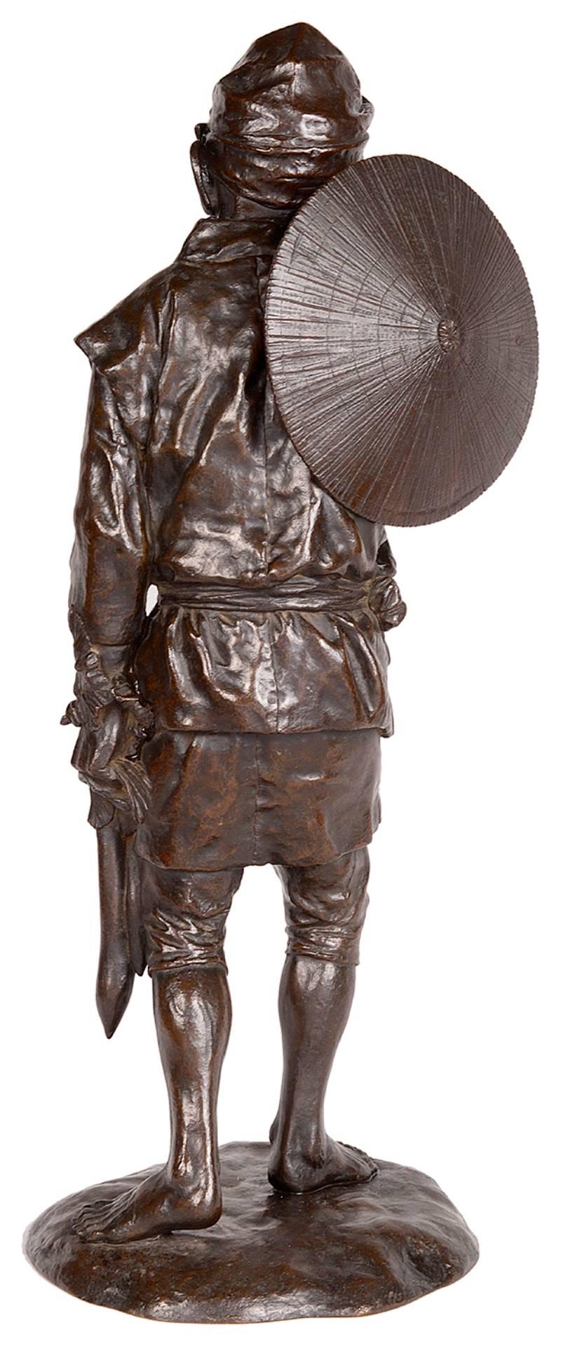 A fine quality, late 19th century (Meiji period 1868-1912) Japanese bronze statue of a farmer. Wearing a Sedge hat and carry his crop of daikon (Winter Radish).