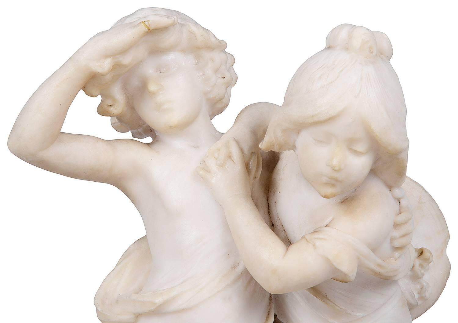 A fine 19th century carved alabaster statue of children playing, signed; Aug. Moreau.