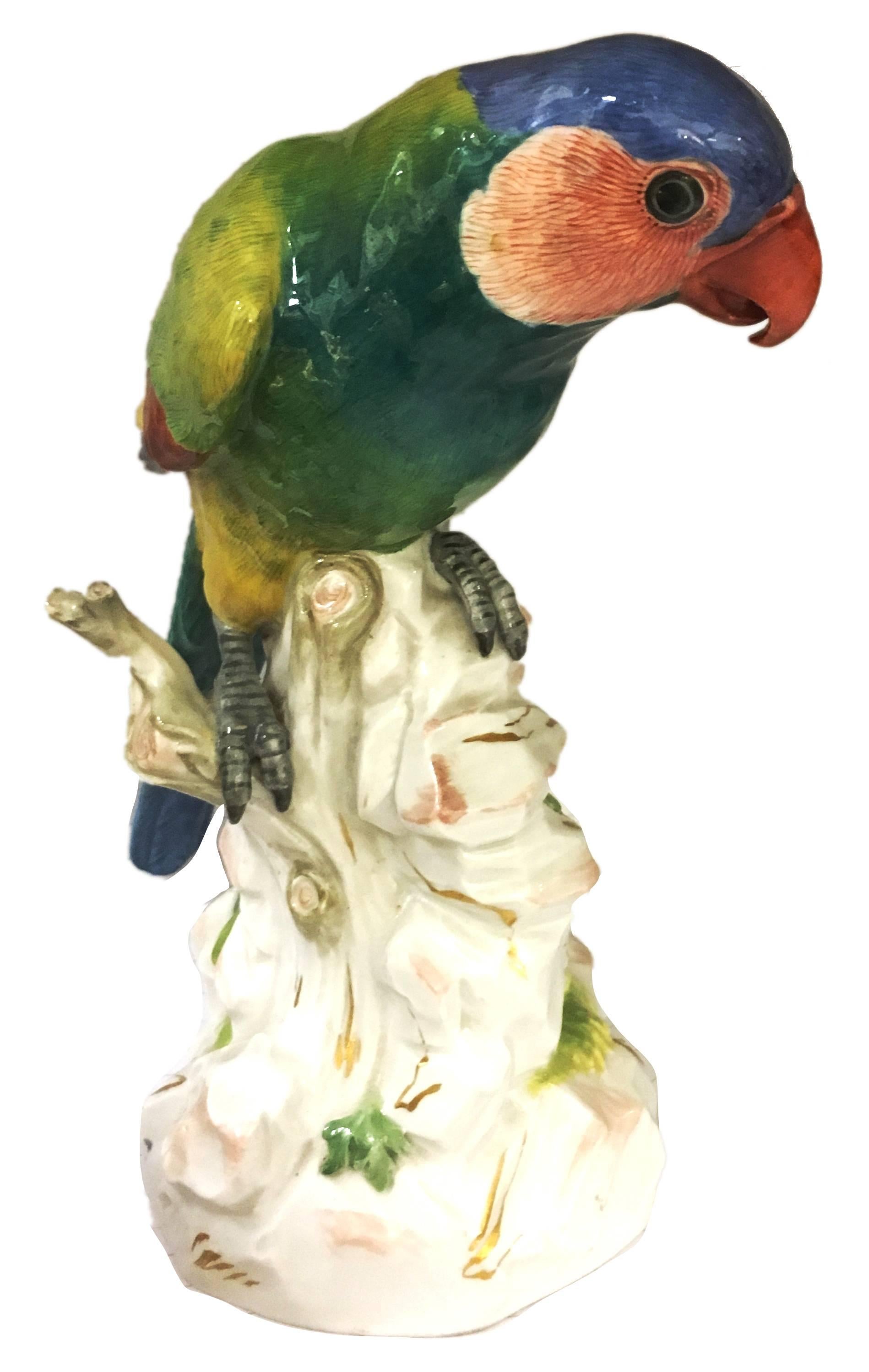 A pair of good quality 19th century Meissen porcelain parrots, each mounted on a trees.