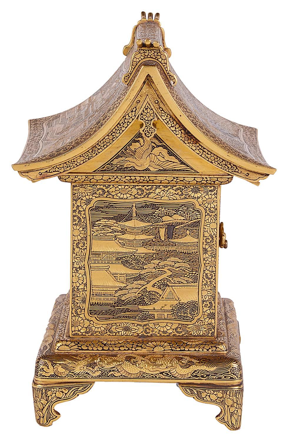 A fine quality Meiji period (1868-1912) Komai workshop cabinet in the form of a temple. The damascened decorated roof with scenes of exotic birds and temples. Doors opening to reveal drawers within all with beautifully engraved decoration birds and