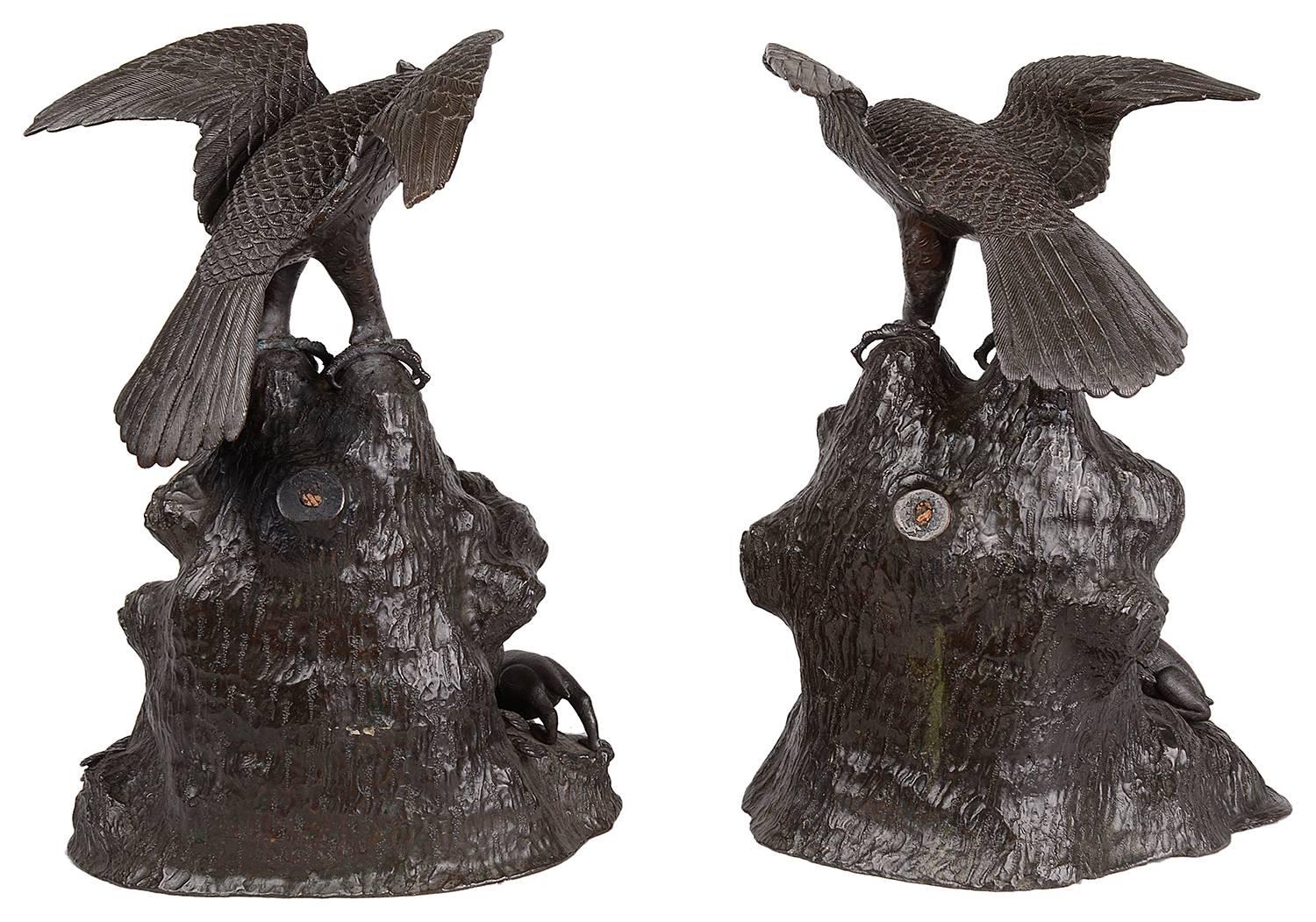 A very good quality pair of 19th Century Japanese bronze Eagles, Meiji period (1868-1912) Each with out spread wings and raised on a rocky outcrop.