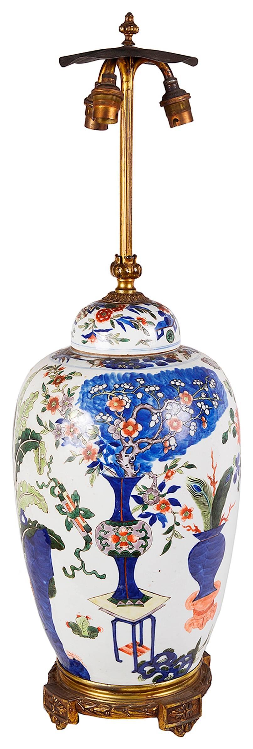 A good quality Chinese famille verte lidded vase / lamp, with a gilded ormolu base.