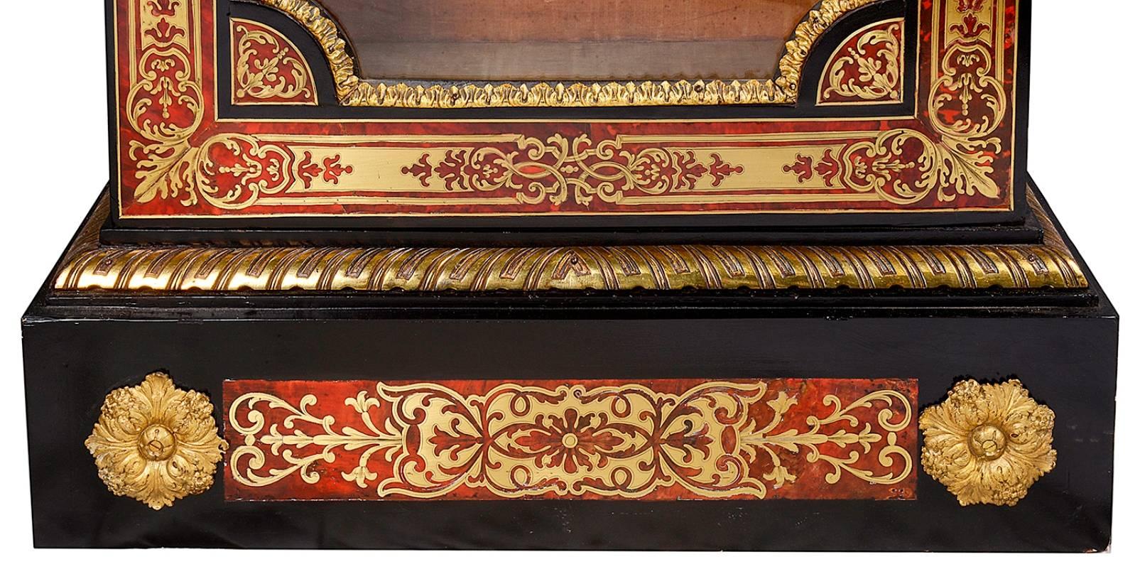 A good quality pair of 19th century French boulle pier cabinets in the style of Louis XVI. Each having marble tops, red boulle inlaid decoration, gilded ormolu mounts. Glazed doors, velvet lined interiors with shelf, raised on a plinth bases.