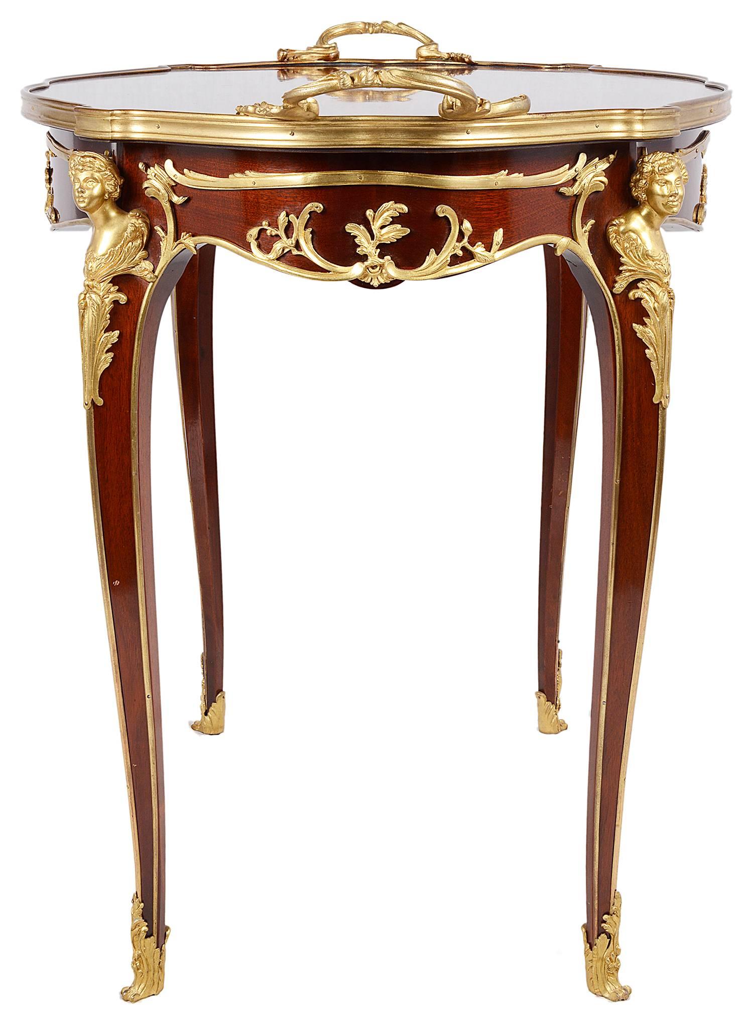 A good quality late 19th century French gilded ormolu-mounted centre table. The top having quartered veneers, rococo style mounts, with monopodia supports to the cabriole legs, terminating in scrolling ormolu feet.