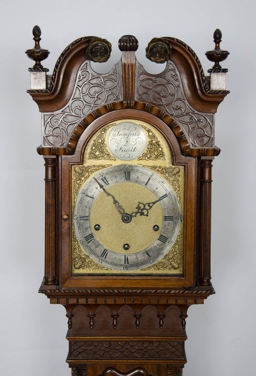 A very good quality Mahogany Chippendale influenced eight day striking Grandmother clock. Having carved and blind fretwork decoration, flamed Mahogany panels to the door and base and raised on ogee bracket feet.