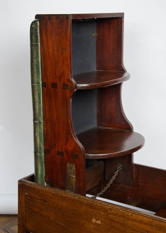 An unusual Georgian Mahogany metamorphic stool/ library steps. Having deep button leather upholstery, raised on square section legs with the original brass castors.
A chain is pulled to release a catch, allowing the steps to hinge up and lock into