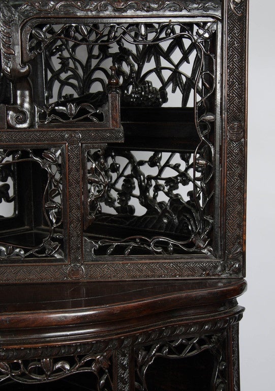 Carved 19th Centuy Chinese hardwood corner cabinet.