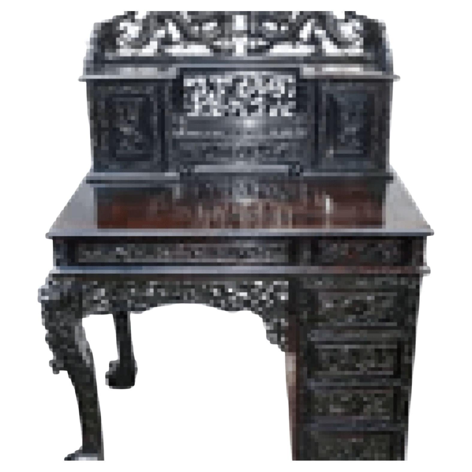 A very good quality 19th century Chinese hardwood knee hole desk, having wonderful classical Chinese hand carving of two Dragons above two cupboards and a drawer, two frieze drawers and a further four drawers to the side. Carved scrolling foliate