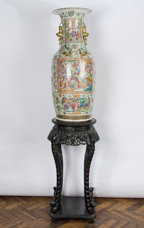 A very large and impressive, good quality Chinese canton or rose medallion vase, depicting classical Chinese scene, set on a beautifully carved Chinese hardwood, marble topped stand.

