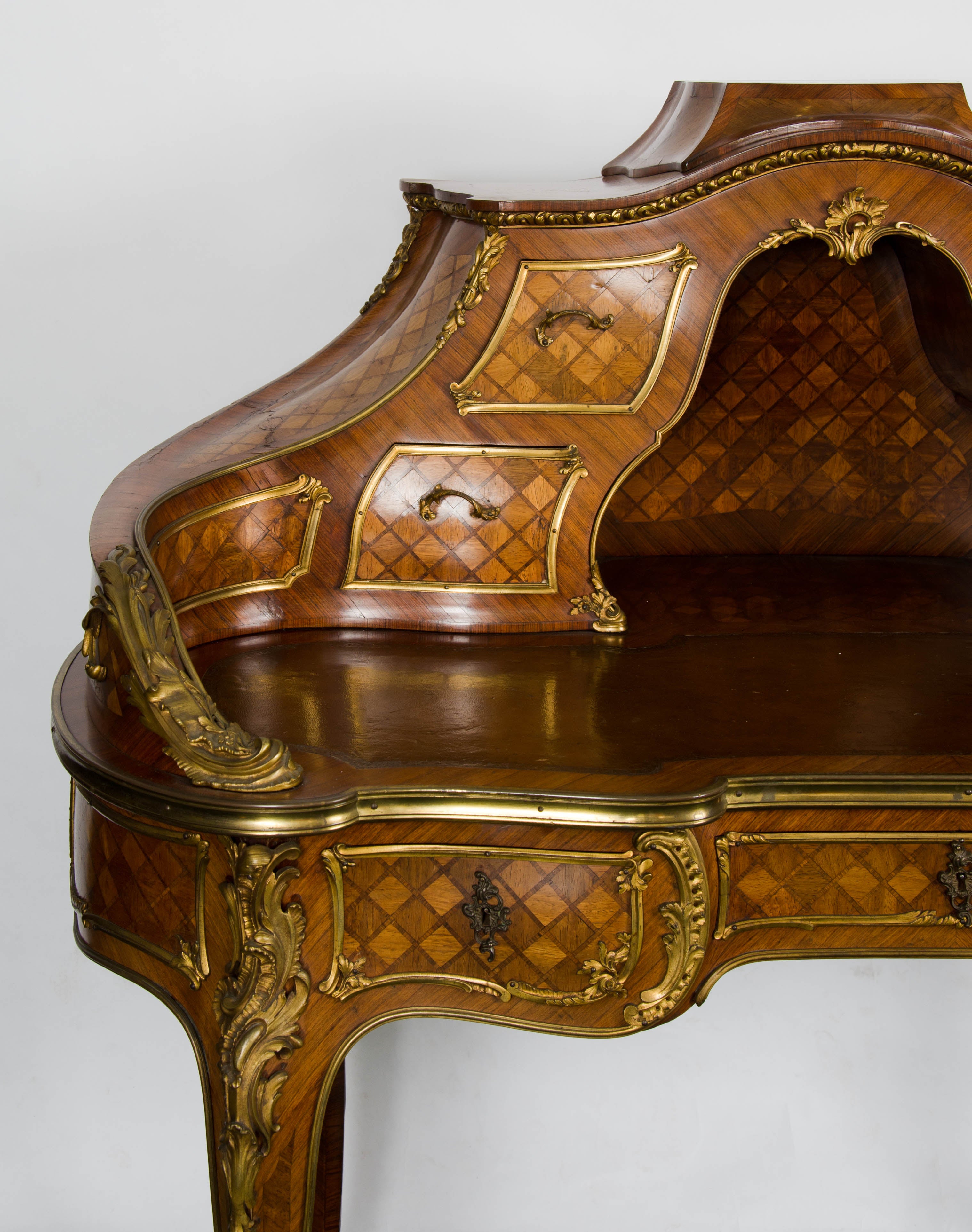 A very good quality French Louis XV style Kingwood, ormolu mounted bureau de dame with parquetry inlaid to the whole, various drawers to the top and frieze, inset leather top and raised on cabriole legs.