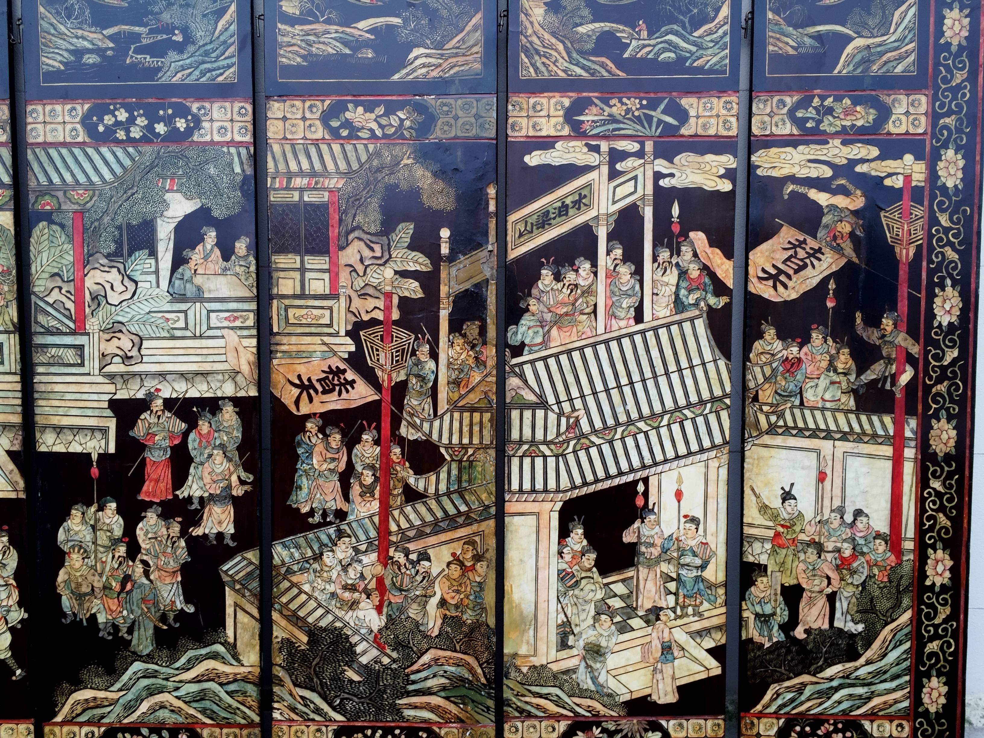 A very impressive and decorative 19th century Chinese coromandel lacquer eight fold screen, depicting a busy palace scene above floral panels. The reverse also decorated with various different panels of people in the garden, flowers and mountains.